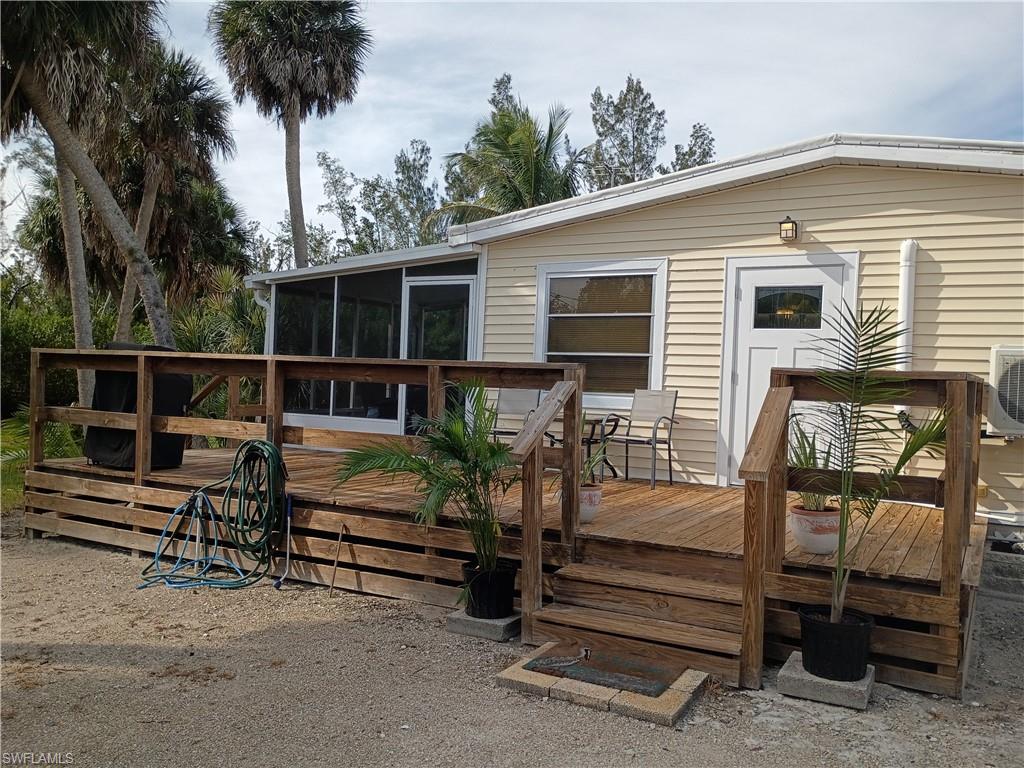 Come enjoy this home with plenty of privacy at the end of Raymary Street in Bokeelia, Fl. One-Two Bedrooms
A must-see property with so many extras - an oversized lot lined with trees and a creek that backs up to the Caloosa Land Trust and Nature Preserve. There are two outbuildings one supplied with tools and a Zero Turn mower. Plenty of room for a pool.
The other building would make a great garden house, studio etc.
The home has a circle drive with a new deck around the side and a screened porch at the front. The back of the home has a screened lanai perfect for morning coffee or evening dinners.
The home is Open Floor plan with eat in kitchen and dining area in bonus room with bar.
Remodeled with new flooring, doors, electric panel, roof coating, power pole.  A turn key with Tommy Bahama furniture - linens-kitchen supplies etc. There is a queen size hideaway bed in the sofa with TV.
Marinas and restaurant's nearby - come bring your fishing gear and start enjoying Pine Island.