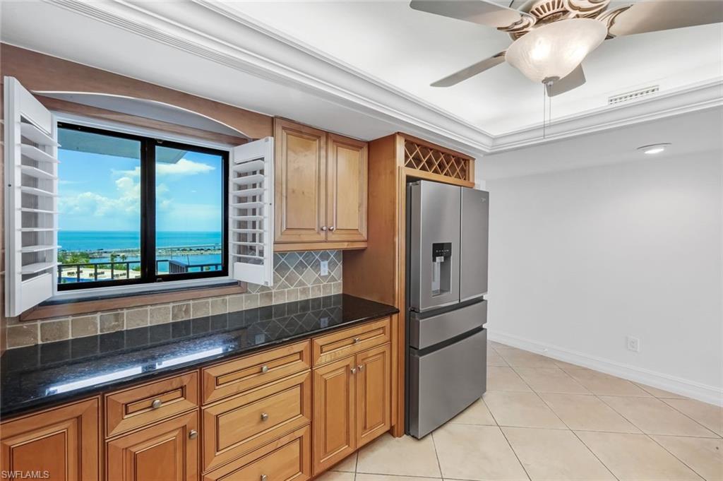 Spectacular Gulf-to-Bay views await from this highly desirable 10th-floor 02 stack residence, offering unobstructed vistas from every window. From the kitchen and guest suite, enjoy panoramic views stretching from Fort Myers Beach and Estero to Naples and Marco Island on clear days. The primary suite and sunroom overlook beautiful Pine Island Sound, creating an ever-changing backdrop of sparkling water and unforgettable sunsets.

This beautifully appointed, turnkey condominium features tile flooring throughout, rich wood cabinetry, granite countertops, a marble backsplash, stainless steel appliances, and an elegant tray ceiling in the kitchen. Both the primary and guest bathrooms are finished with wood cabinetry and marble countertops, adding timeless style and quality.

The expanded floor plan includes an enclosed former lanai with sliding windows, screens, and custom sun shades, creating additional year-round living space while maximizing the incredible waterfront views. The laundry room offers extra cabinetry and a stacked washer and dryer, and a charming French door adds character to the guest suite.

Offered fully furnished with beautiful Lexington Tommy Bahama and Henry Link furnishings, this residence is truly move-in ready. Major updates include a new air conditioning system and hot water heater installed in 2024.

Additional conveniences include an assigned parking space and private storage.

Punta Rassa continues to enhance the community with new landscaping scheduled for July 2026, parking area resurfacing planned in the coming months, completed walkways, and newly refreshed tennis and pickleball courts ready for residents to enjoy.

Ideally located adjacent to the Sanibel Harbour Yacht Club and the Sanibel Harbour Marriott Resort & Spa, you'll have easy access to waterfront dining, marina, and the gateway to Sanibel and Captiva Islands.

This is an exceptional opportunity to own a coveted high-floor residence at Punta Rassa, where breathtaking views, quality finishes, and an outstanding waterfront location combine to offer the very best of Southwest Florida living.