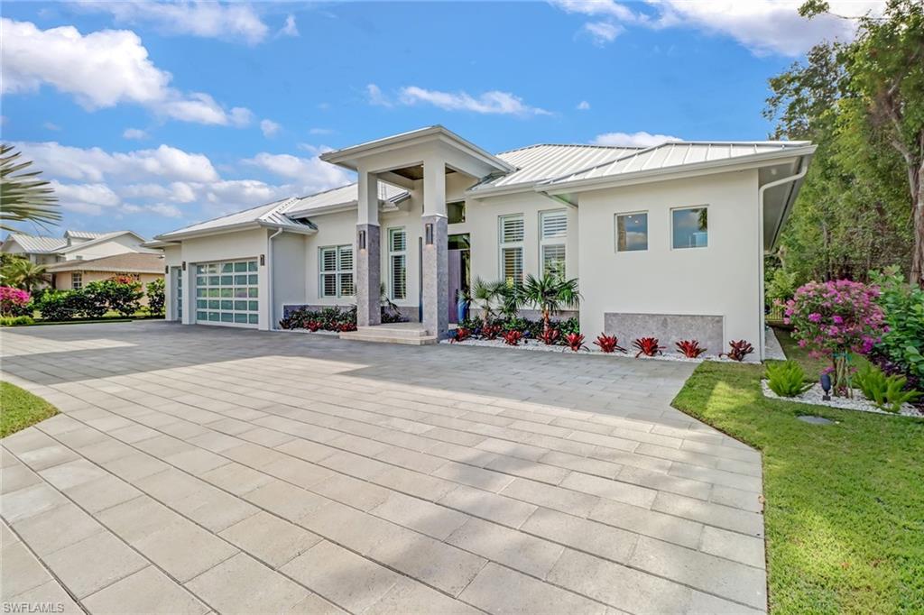 This one-of-a-kind gem in the heart of Coquina Sands will have everything you're searching for! Nothing will compete against this NIAN Custom Home! One step into this luxury oasis will leave you speechless. As you enter this upscale property you will instantly be greeted by a gracious open concept floor-plan boasting an 80 bottle wine cellar and a stunning pool with water feature peering through a 12-foot tall glass wall, all complemented by beautiful oak flooring and marble countertops. Everything in this home has had tremendous attention-to-detail including custom carpentry around the entertainment center with fireplace, Monogram appliances, gas cook-top, detached double fridges and a chef's pantry! Continuing out onto your patio, you will be greeted by an outdoor living space which includes an additional fireplace, outdoor gas grille with sink, all giving you that sensation of being at a private resort! Your luxurious master suite includes his & her walk in closets, a separate tub & a large walk-in shower with multiple shower heads and sauna feature! Other upgrades include mosquito spray system, landscape uplighting and motorized indoor shades in the living room.