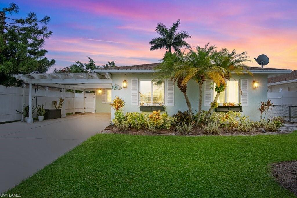 Motivated Seller, investors take note! Located on one of the most desirable streets in Naples Park, this beautifully renovated home offers the perfect combination of modern upgrades, coastal charm, and investment potential. The property has undergone extensive improvements, including plank porcelain tile flooring throughout, updated interior and exterior paint, impact-resistant windows and doors, stylishly remodeled bathrooms, updated lighting, and a custom solid-wood carport with a light-filtering roof cover. Designed for comfortable indoor-outdoor living, the expanded kitchen features abundant counter space, an island with a striking 3-inch quartz countertop, and additional storage rarely found in Naples Park homes. The spacious screened and tiled lanai provides the ideal setting for entertaining, relaxing, or enjoying the Southwest Florida lifestyle year-round. Naples Park continues to be one of Naples' most sought-after vacation rental destinations. Just minutes from Vanderbilt Beach, Delnor-Wiggins Pass State Park, Mercato, world-class dining, shopping, and entertainment, this property is perfectly positioned as a primary residence, seasonal getaway, or income-producing investment.