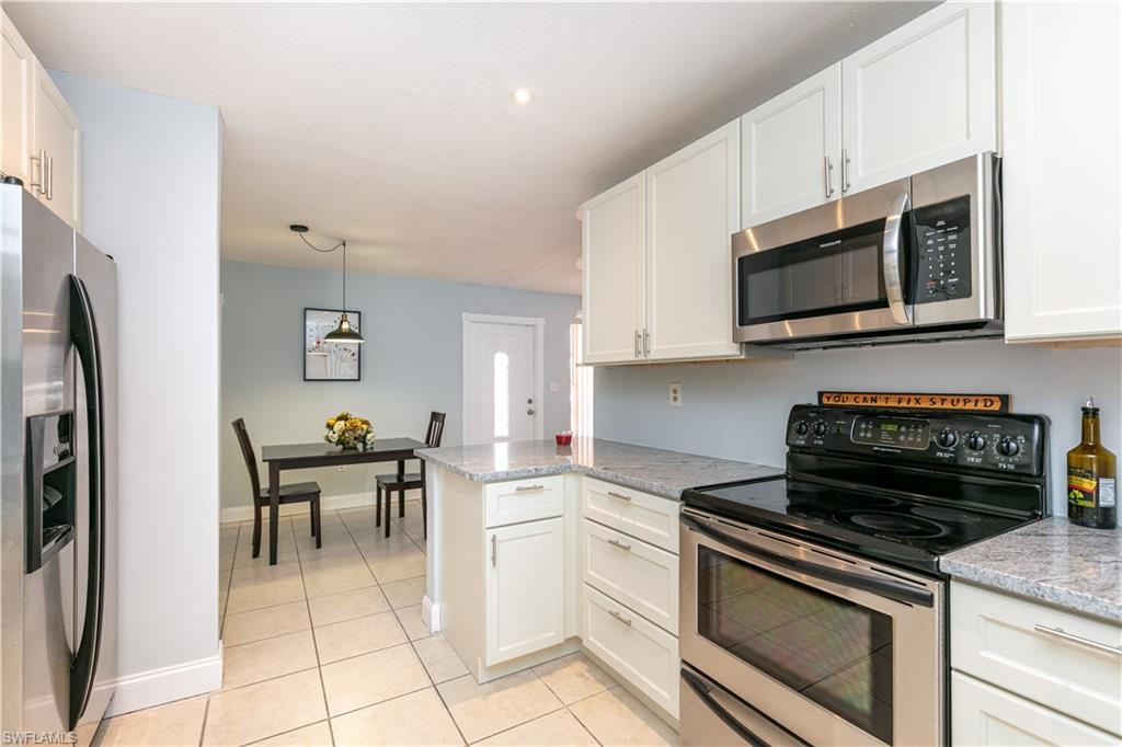 Absolutely STUNNING  2/2 Designer  Home which has been totally remodeled! Like Brand new construction,Gorgeous white shaker cabinets in Kitchen and designer high end white granite,new stainless steel refrigerator. Very Open layout for entertaining.New tiled floors through out, remodeled designer bathrooms with new vanity,lights,mirrors,designer tiles. Entire house repainted inside and outside, newly painted driveway, new landscaping, new Roof,new ac. Newly painted huge lanai, new lighting through out home, and brand new interior doors,and new baseboards. You will fall in LOVE with this breathtaking home! Stores,shopping,restaurants,hospitals,are close by