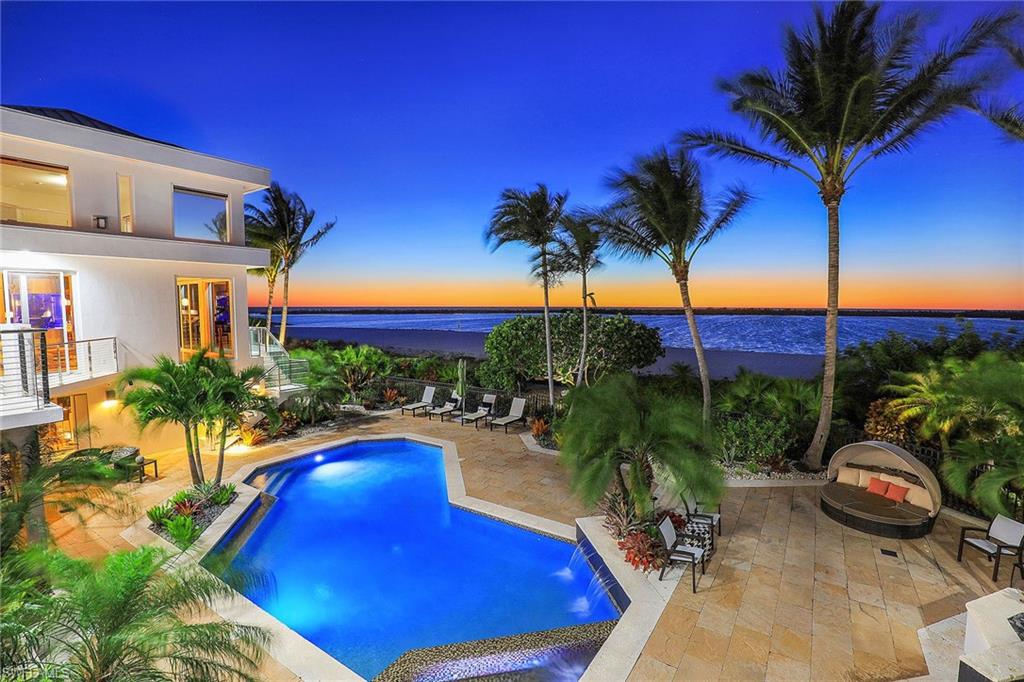 The epitome of luxury living, this beachfront mansion sits on a nearly 1-acre double lot, featuring 180-feet of rare beach frontage on the Gulf of Mexico. This contemporary mansion encompasses 3 stories of luxury living with windows and walls of glass that capture Gulf and beach views. Guests are welcomed through a 30-foot foyer and a statement staircase with glass rails soaring to the 3rd floor. The artfully designed interior includes 5 bedrooms, 5 full baths and 3 half baths, as well as a top-floor office and art gallery. The stunning great room framed with glass overlooks the Gulf and beach, offering a custom wet bar and fireplace. A state-of-the-art kitchen is an entertainer's dream, with Poggenpohl cabinets, a specialty granite countertop and Miele/Wolf appliances. The spectacular double-glass entrance reveals the secluded master suite with fireplace and 10-foot sliding doors that open to a private outdoor living area. Five terraces overlook the vast estate, all with incredible Gulf views. Surrounded by lush landscaping, the resort-style grounds are complete with a saltwater infinity-edge pool and fountain, a cabana room off the pool with a kitchen, bar and bath, and a gathering room with a fireplace. Nestled in the prestigious community of Hideaway Beach, this 24-hour gated community features 2 miles of white sand beach, a clubhouse on the beach and world-class amenities.