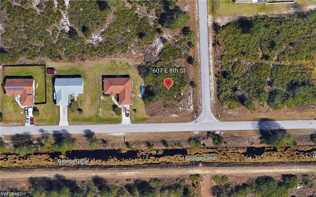 Fantastic opportunity to own land in SWFL! This oversized corner vacant land parcel is zoned single family and is located in one of the fastest growing areas of Lee County. Situated in a non-gated, non-deeded neighborhood w/ NO HOMEOWNER FEES! Short drive to shopping & dining, easy access to Fort Myers, and less than 3 miles from the massive Veterans Park Recreation Center that has activities for everyone!