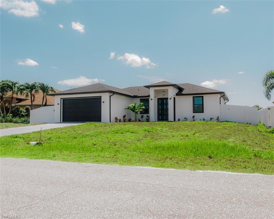 Brand new 2026 construction in Northeast Cape Coral sitting on a canal with NO flood insurance required. Built with concrete block, impact-resistant windows and doors, and a shingle roof — this home is as solid as it gets. Inside this three bedroom two bathroom home, you will find an open great room layout, tile floors throughout, a kitchen with an island and breakfast bar, tray ceilings, and a split bedroom floor plan. The primary suite features dual sinks and a walk-in closet. Step outside to your open lanai with peaceful canal views, a fenced yard, and an auto irrigation system. No HOA, no restrictions, makes this one of the best value plays in Cape Coral today.