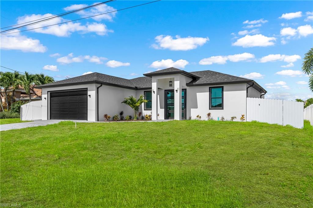 Brand new 2026 construction in Northeast Cape Coral sitting on a canal with NO flood insurance required. Built with concrete block, impact-resistant windows and doors, and a shingle roof — this home is as solid as it gets. Inside this three bedroom two bathroom home, you will find an open great room layout, tile floors throughout, a kitchen with an island and breakfast bar, tray ceilings, and a split bedroom floor plan. The primary suite features dual sinks and a walk-in closet. Step outside to your open lanai with peaceful canal views and a fenced yard. No HOA, no restrictions, makes this one of the best value plays in Cape Coral today.
