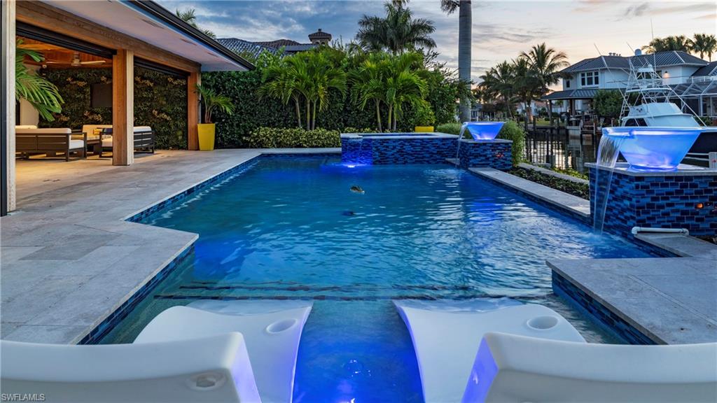 Welcome to 1650 Mullet Court, where luxury waterfront living meets effortless, move-in-ready perfection. Located in the coveted Royal Harbor community with direct Gulf access, this fully furnished, masterfully renovated home delivers the kind of lifestyle buyers dream about, but rarely find available.

From the moment you enter, vaulted ceilings, natural light, and an open, airy flow create an unforgettable first impression. Every inch of this home has been finished to the highest standard, offering the elegance of a new build with the warmth of a thoughtfully curated coastal retreat.

At the heart of the home, the chef’s kitchen stuns with custom cabinetry by Woodworkers of Naples, dramatic Cristallo stone, and elite appliances including Wolf double ovens, a five-burner gas cooktop, two Cove dishwashers, a Scotsman clear-ice maker, and Thermador refrigeration. The custom backlit Cristallo stone entertaining bar is a showpiece. Perfect for evening cocktails, celebrations, or hosting with ease.

The primary suite is a true sanctuary, featuring a spa-like bathroom with an oversized frameless shower, multiple shower heads, and a beautifully designed dressing room that adds a true custom-luxury touch.

The outdoor living space is where this property becomes truly irresistible. Surrounded by leathered travertine pavers, cedar tongue-and-groove ceilings, and architectural cedar columns, the lanai feels like a private boutique resort. Enjoy a heated saltwater pool and spa, illuminated glass-bowl water features, an Alfresco outdoor kitchen, electric roll-down screens, and multiple lounge areas designed for both relaxation and unforgettable entertaining.

As the sun sets, the real magic begins. Step down to the water’s edge, gather by the gas firepit, and watch the boats drift along the bay. The brand-new dock, reinforced with all-new pilings and decking, accommodates up to a 65-foot vessel, plus a Hydro Hoist lift for a 32-foot boat, offering unmatched convenience and direct access to Naples Bay and the Gulf within minutes.

This home is equipped with every modern upgrade: hurricane impact windows and doors, electric shutters, a 26 kW generator, Culligan whole-home filtration, new aluminum roof, upgraded landscaping with lighting, a newly designed circular paver driveway, & custom flood barriers.

Perfectly located just moments from Olde Naples’ world-class beaches, restaurants, and boutique shopping, this home delivers a lifestyle that is turnkey, elevated, and exceptionally rare.

Homes of this quality, fully renovated, fully furnished, with direct Gulf access, do not linger on the market. This is a must-see property. Schedule your private showing today before this opportunity is gone.