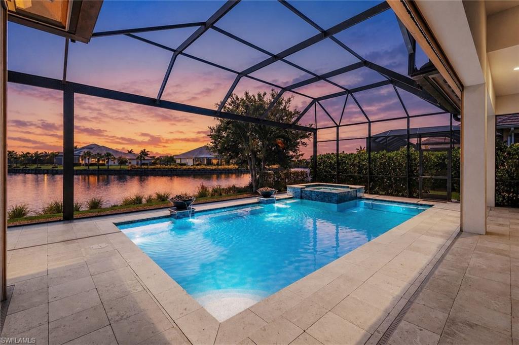 Located on Lightbourn Way in the Isles of Collier Preserve, this 2017 Stock-built Marigold model is one of the community’s largest floor plans. Lightbourn Way is a 7 minute walk or 4 minute bike ride to neighborhood amenities, including the Overlook Bar & Grill, 12 pickleball courts, 4 tennis courts, a clubhouse with fitness center and meeting rooms, a basketball court, a resort-style pool, a lap pool, and a kayak launch. Even with close proximity to the amenities, the home is optimally oriented for peace and quiet. Extensive nature trails are minutes away, and the community’s 12-foot-wide sidewalks make walking and biking easy.  
The home’s western-facing lanai captures a coveted long-water view and spectacular year-round sunsets. The covered outdoor living area includes a gas fireplace, TV, full outdoor kitchen, and storm shades. The saltwater pool evokes a private resort with gas fire bowls, a large spa, and a no-see-um screened enclosure.
Inside, you’ll find 4 generous bedrooms, 4.5 baths, and an owner’s suite with a walk-in shower, separate soaking tub, custom walk-in closets, a sitting area, and French doors opening to the pool and spa. The office/library with custom built-ins and window seat make working from home a dream. The gourmet kitchen features a cooktop, two convection ovens, a large island with seating for four plus an eat-in nook and adjacent formal dining room.
With its prime location, peaceful setting, western exposure, and beautiful water views, this home is a rare find.