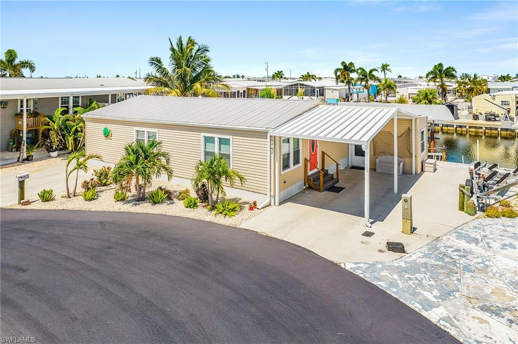 Beautiful renovated waterfront Home in Cherry Estates – Move-In Ready!

Don't miss this incredible opportunity in the highly desirable Cherry Estates community on Pine Island! Set on a spacious cul-de-sac lot with 90 feet of waterfront frontage, this home is positioned broadside to the canal, offering breathtaking views of intersecting canals and an unbeatable island setting.

Nearly every inch of this home has been upgraded, including a newer carport, plumbing, completely updated electrical with new outlets and switches, new windows, doors, and sliding glass doors, and a newer HVAC system and ductwork. Additional improvements include new flooring and moldings, a reinforced subfloor with two layers of ½-inch plywood, ½-inch OSB insulation around the entire home, closed-cell foam insulation underneath, and extra tie-down straps for added peace of mind.

Boaters will love the composite dock, 10,000-pound boat lift, NEW Canopy and large fishing shed. This location provides quick access to some of Southwest Florida's best fishing, boating, waterfront dining, and Gulf adventures. The home is partially furnished, making your move even easier. Explore the island by boat or golf cart, where waterfront living, spectacular sunsets, and laid-back island charm await.
