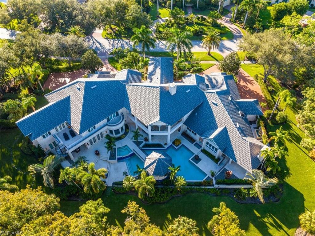 Pre inspection report available.  Luxury living on an expansive 2-acre lot nestled in the ultra prestigious community of Quail West. With an impressive 11,000 square feet of living space, this estate comprises 6 generously sized bedrooms, 2 stately offices, a media/game room, and multiple elegant entertaining areas, defining it as a true estate by every measure. The living room exudes grandeur with its soaring ceilings. This home has been extensively upgraded to match its grandeur, including a gourmet kitchen featuring custom cabinets and exquisite granite countertops, luxurious tile and marble flooring, intricate wood trim, coffered ceilings, a surround sound audio system, and an expansive master suite that encompasses his and her closets, a steam room, sauna, an exercise room, and a living room with a cozy fireplace. Additional notable features include a private elevator, a five-car split garage, custom closets, and electric shutters on all windows for added convenience and security. The exterior lanai is a true oasis, showcasing a stunning pool and spa with cascading waterfalls, a picturesque bridge spanning the pool leading to the outdoor kitchen, and an expansive lanai overlooking the tranquil golf course.