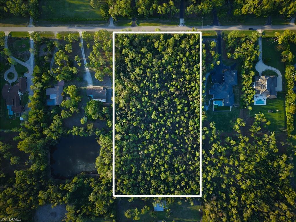 One of the last remaining undeveloped estate lots in the established Livingston Woods community, this 5-acre assemblage represents a truly turnkey development opportunity in North Naples — with the hard work already done. The Environmental Resource Permit has been issued, authorizing construction of a single-family residence, detached barn, and associated structures. Mitigation credits have been purchased, and the permit is active through January 2031. The property features a thoughtfully designed site plan with a 237' x 191' residence footprint (up to 12,000 +/- square feet, proposed barn, and dual driveway access — all within a 5-acre perimeter-fenced estate setting. For the discerning buyer looking for privacy, convenience, and even horses without the 12–18 month permitting gauntlet, this parcel delivers immediate path to construction. Comparable permitted lots in Naples at this acreage are virtually nonexistent.