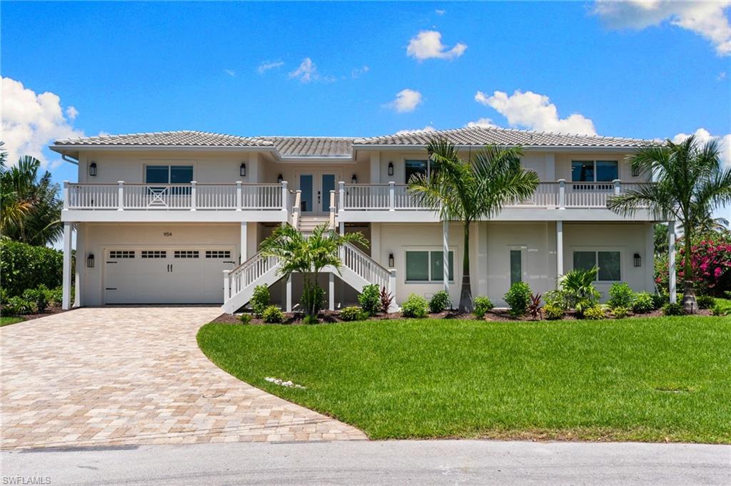 Welcome to one of Shell Harbor's finest canal lots — completely transformed and ready for its next chapter. This stunning 4-bedroom plus den, 4-bath home on Sanibel's coveted east end has been newly elevated and fully renovated, delivering the perfect fusion of modern resilience and island luxury. Perched on a prime corner lot in a quiet cul-de-sac, the property commands an impressive stretch of canal frontage with sweeping multi-canal views, made all the more dramatic by its elevated position. Below, an oversized dock and boat lift offer seamless access to San Carlos Bay and the Gulf of Mexico — a true boater's paradise. Inside, the great room serves as the heart of the home — sun-drenched, open-concept, and anchored by a handsome tray ceiling. The gourmet kitchen impresses with quartz countertops, a spacious center island, and high-end appliances, while elegant light tile flooring flows effortlessly throughout. Every bedroom is generously proportioned and paired with its own private bath, and the custom bunk room is a showstopper that family and guests will love. Step outside and the magic continues. Panoramic screens frame the water views from every angle, blurring the line between indoors and out in true Sanibel style. The composite deck overlooks an oversized sparkling pool — an ideal setting for sunset dinners or quiet mornings watching the manatees drift by. The large lower level provides opportunity for ample storage and parking with sliders out to the pool deck.  A meandering stone path leads you down to the composite deck — a generous, sun-kissed retreat designed for lingering. Whether you're settling in for a long al fresco dinner, watching the boats glide past, or simply soaking in the canal views as the day winds down, this space invites you to slow down and savor every moment of island living at its finest  Deeded beach access with a private parking lot is just steps away, and the east end location means easy on-and-off island access with close proximity to the bike path, shops, and restaurants.  Move-in ready, fully elevated, and impeccably renovated — opportunities like this on Sanibel's finest canal lots are extraordinarily rare. Don't miss your chance to make this island dream your own.