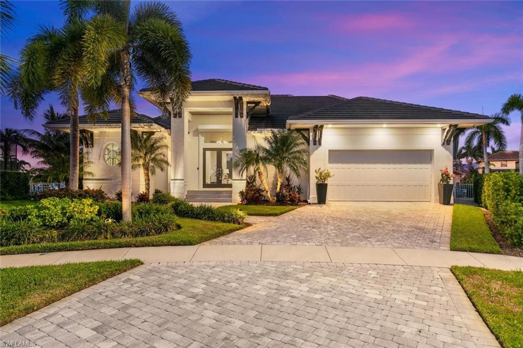 Paradise found! Not only is this magnificent home a boaters paradise, it invites you to savor the pinnacle of luxury coastal living. Take in the breathtaking water views from dawn to dusk, thanks to its favored southeastern exposure. And when you’re ready to cool off from the Florida heat, the infinity pool and sun shelf await. Imagine crafting culinary delights in the open concept kitchen while friends and family mingle in the great room. The spacious lanai offers another backdrop for gatherings, where an inviting outdoor living room allows you to relish the tranquil surroundings under the stars. With not one, but two boat lifts, open waters are only 25 minutes away. Take your boat to Keewaydin Island, a sanctuary of untouched beauty and if the mood strikes, cruise your boat to one of the famous Marco Island restaurants for a memorable lunch by the water. After a day of casting your line and reeling in your catch, prepare for a feast in your outdoor kitchen. The allure of Marco Beach, with its powdery sands and azure waters, is always at your doorstep, ready to whisk you away. Don’t miss your chance to experience the ultimate in coastal living!