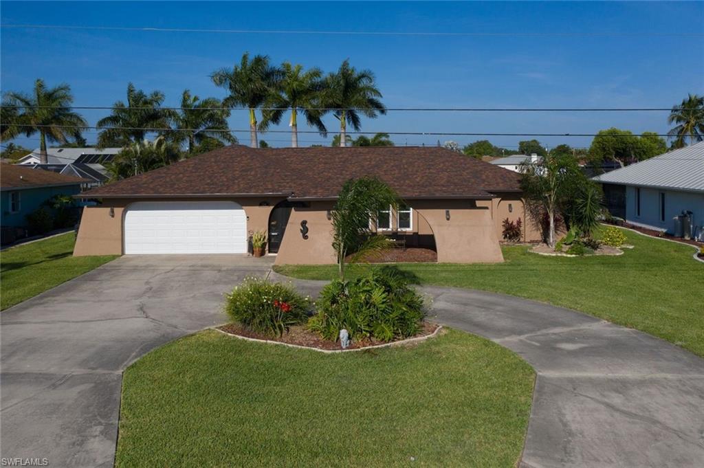 This beautiful home is located on the stunning Rubicon Canal. This spectacular 3/2 heated pool will captivate you everynight with the amazing sunset views over looking an spectacular  brick pavered lanai pool.  Look no further, this home has so many upgrades such as, Granite Countertops, Beautiful White Cabinets, Roof-2018, 2017-Hot Water Tank, 2019- Hurricane Impact Windows, AC-2021 the whole house was completly redone including all the ducs.  House is wired for a whole house portalbe generator that runs on gas or propane (instructions are on the wall ). Exterioir of the house has been freshly painted & it even offers a circle driveway.  The stunning Royal Palms and Landscaping are breathtaking and will have you saying, "This is what Florida is all about!" 2020- new canopy for you boat and the dock was upgraded as well.  Did I mention even both bathrooms have been upgraded and their is a pool bath too!! AND, NO FLOOD INSURANCE & ASSESSMENTS ARE PAID!  There truly is nothing better than to sit and bask in the sun or cast your fishing pool while sipping on a glass of wine watching our amazing SWFL sunsets!  Dosen't that sound like paradise?