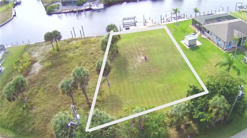 Build your dream waterfront retreat on this exceptional cleared Gulf-access lot located in the highly desirable Shores of Fort Myers. Situated on a wide intersecting canal, this prime property is already equipped with a seawall, wraparound dock, and a 27,000-pound boat lift with both electric and solar power installed. Boating enthusiasts will appreciate the deep-water canal that can accommodate larger vessels, including yachts, with easy navigation through the intersecting canal to the Caloosahatchee River and direct access to the Gulf of Mexico. Best of all, there are no locks or lifts to navigate along the way. The lot has been cleared and fill has already been brought in, providing a head start on building your custom waterfront home. Enjoy breathtaking water views, spectacular sunsets, and the unique opportunity to watch dolphins and manatees right from your backyard. Ideally located, this waterfront property offers the perfect balance of privacy and convenience. Enjoy easy access to shopping, dining, entertainment, and outdoor recreation, while remaining just minutes from I-75 for seamless travel throughout Southwest Florida. Downtown Fort Myers' vibrant River District, with its restaurants, boutiques, and waterfront attractions, is just a short drive away, and Southwest Florida International Airport is within easy reach. Whether you're envisioning a luxury waterfront estate, seasonal getaway, or boater's paradise, this rare offering provides the ideal setting to enjoy the very best of Southwest Florida living. Don't miss your opportunity to own a slice of paradise.