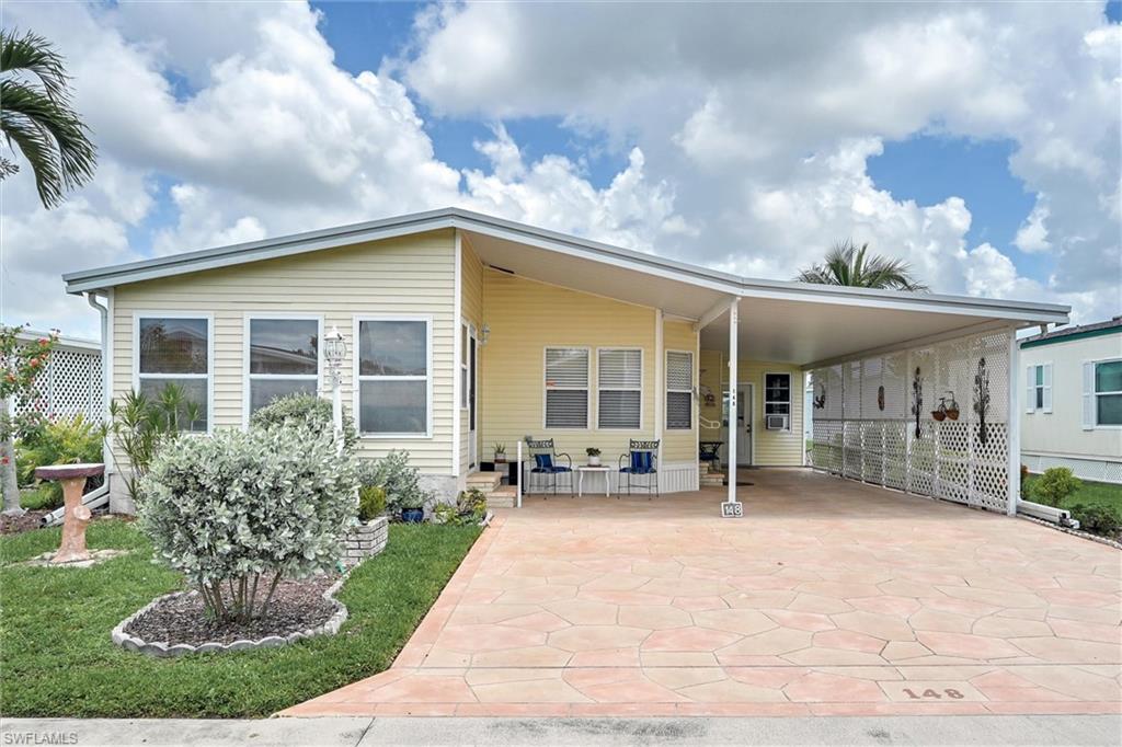 Welcome to your piece of paradise in Windjammer Village of Naples, a 55-plus gated community offering the Florida lifestyle. This charming two-bedroom, two-bathroom manufactured home features a bright and spacious open floor plan that is perfect for entertaining or relaxing. At the front of the home, a wonderful Florida room floods the space with natural light, providing the ideal spot for your morning coffee or curling up with a good book.
The exterior boasts low-maintenance vinyl siding and a generous covered carport with enough space to comfortably park two vehicles. Tucked neatly under the carport, you will find a spacious storage shed that has been perfectly utilized as a workshop, offering great versatility for hobbies, tools, or extra storage.
Living in Windjammer Village means enjoying a resort-style atmosphere every single day. The community has fantastic amenities, including a clubhouse, a sparkling swimming pool, a relaxing spa, and plenty of ways to stay active with tennis courts, shuffleboard, and bocce ball. Combining comfort, convenience, this home is ready for its next chapter. 2 pets allowed.