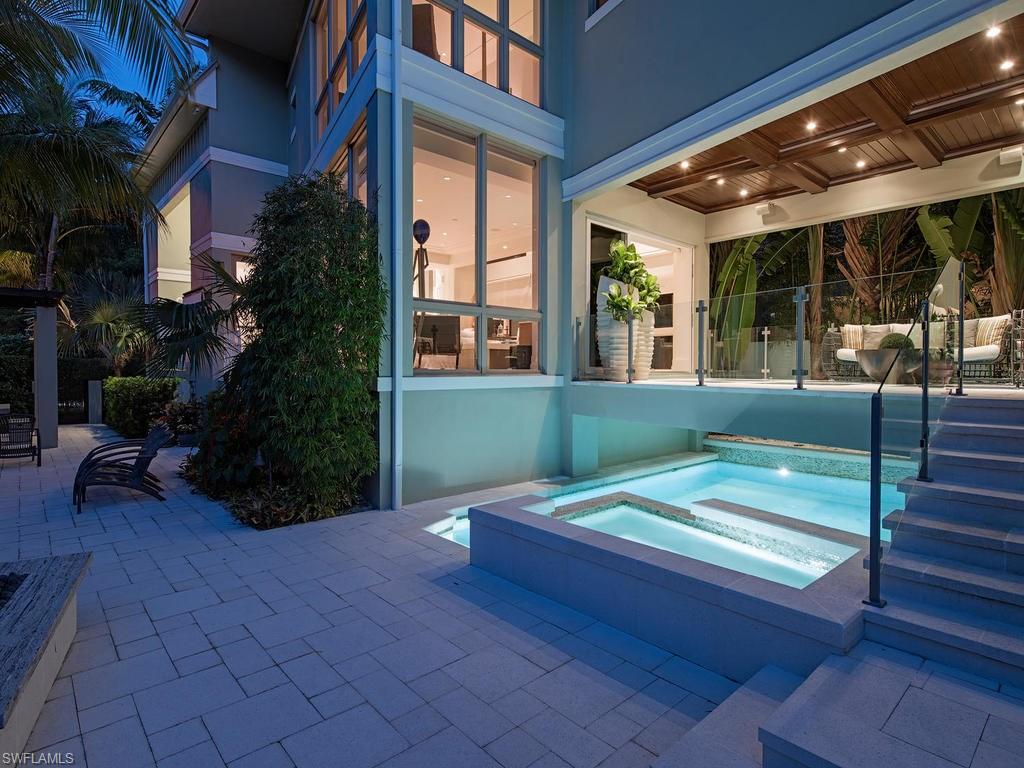 Built in 2013 by Naples Redevelopment, this is the last home built in the cherished Gables development (total of 7 homes). This is the most popular model in this special enclave of homes and was designed by Jeff Harrell and Associates. Comprised of 3 bedrooms, 3 baths plus a powder room, custom designed European Oak hardwood floors throughout, a Miele appliance package, floor to ceiling glass walls, custom cabinetry and marble counter tops this property offers a very high level of finish. The outside features a covered living area that seems to float above the pool with large glass inserts in the deck, private spa and waterfall. The expansive yard also features a pergola and fire table with complete privacy. The home was professionally designed and furnished by Kelly Godsey Design. Just a short stroll or bike ride away from the white sand beaches and fine dining/shopping of 5th Avenue South.
