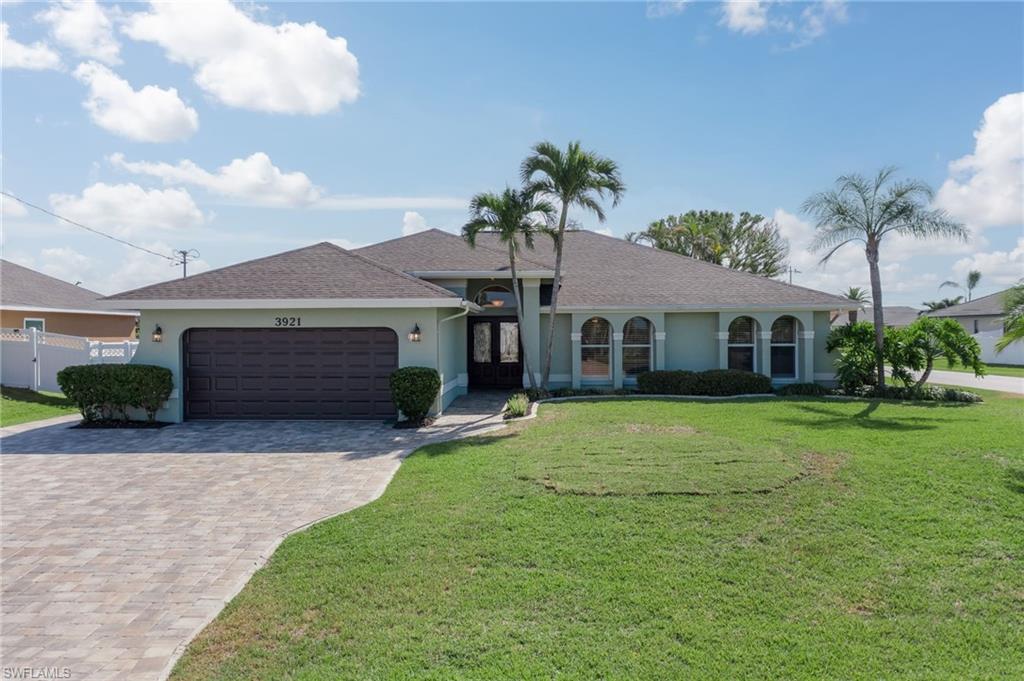 Buyer defaulted so Back on Market!  NEW ROOF!  ALL NEW HURRICANE IMPACT windows, sliders and door across the back elevation.  This 3BR plus den pool home resides on a corner lot in a desirable SW Cape neighborhood just off of Oasis Blvd.  Wood beams and dimmer lights added to the living room’s vaulted ceiling.  NEW OUTDOOR KITCHEN and POOL/SPA HEATER make this the perfect place to entertain family and friends.  The kitchen has granite countertops, updated backsplash and new stainless steel appliances.  The den offers a great flex space with custom queen MURPHY BED and dual closets (Appraiser counted as 4th BR).  Guest bath updated with white subway tile. Other exterior features include extra wide paver driveway, new hurricane garage door with new opener, extended lanai with fireplace and vinyl fenced yard.  Schedule a tour today!