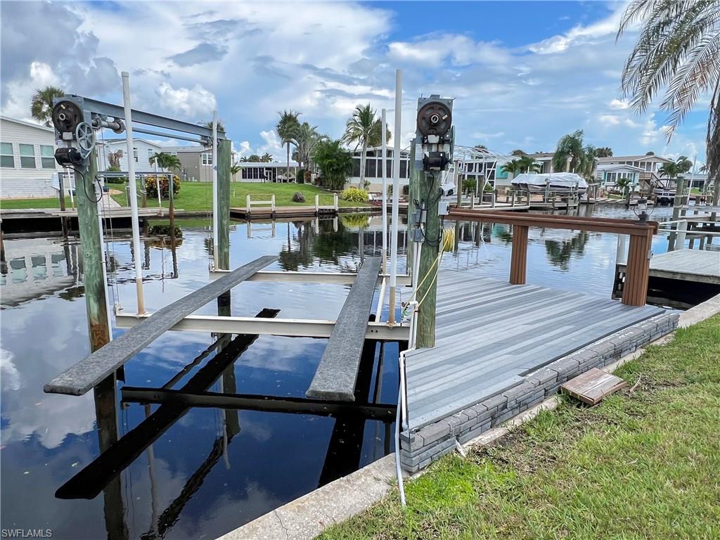 Fort Myers Beach’s Best-Kept Boating Secret! Welcome to Bayside Estates — a vibrant, tropical 55+ boating community where your dream coastal lifestyle is ready to begin! Picture yourself building your oasis on this oversized, pie-shaped lot, perfectly positioned just a short stroll to the clubhouse and sparkling pool. Offering morning coffee with breathtaking sunrises and refreshing, shaded afternoons on your private lanai or dock. With a generous 96’ of frontage, this lot offers space for a two-car garage. For water lovers, your own composite dock and boat lift provide Gulf access for endless adventures. Just 2.5 miles from iconic Fort Myers Beach, you’ll enjoy quick access to powdery white sands, waterfront dining, shopping, and vibrant local entertainment. Bayside Estates is more than a fantastic community—it’s a lifestyle. Dive into an abundance of social activities, pickleball, tennis, shuffleboard, bocce, horseshoes, and more. Low quarterly HOA fees include lawn care, high-speed internet, sewer, water, trash, recycling, reclaimed irrigation, and onsite management—so you can focus on what matters: living your best coastal life. And yes—it’s pet-friendly, too! Embrace leisurely morning strolls, exciting boating and beach days, and breathtaking sunsets—the true essence of coastal living! Buyers in Bayside pay a $2800 resale capital contribution fee.
