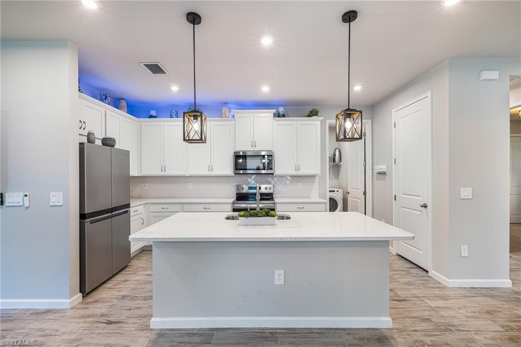 Welcome to Bonavie Cove, one of Fort Myers' most desirable gated communities. This beautiful 2-bedroom, 2-bath Largo paired villa offers the perfect combination of modern design, low-maintenance living, and an unbeatable location near the new Lee Health hospital campus and exciting future growth coming to the area.

Built in 2025 and loaded with over $50,000 in upgrades, this home is truly better than new. Recent additions include a custom garage storage system, built-in home office cabinetry, and a Murphy bed, providing exceptional flexibility for guests, remote work, or hobby space.

Inside, the thoughtfully designed single-story floor plan features an open-concept great room that flows seamlessly into the kitchen and dining area. The kitchen showcases light coastal-inspired cabinetry with soft-close doors and drawers, backsplash, quartz countertops, and a large center island perfect for entertaining. Luxury tile plank flooring runs throughout the main living areas. 

The spacious primary suite features a large walk-in closet and an elegant ensuite bath with dual sinks, quartz countertops, raised-height vanity cabinetry, and a floor-to-ceiling tiled shower. 
Step outside to the screened lanai and enjoy peaceful indoor-outdoor living in a private setting. Additional features include impact-resistant windows, ENERGY STAR appliances, a washer and dryer, and a two-car garage.

Bonavie Cove offers resort-style amenities including a sparkling community pool, fitness center, fire pit, social terrace, grilling area, walking paths, dog park, and beautifully maintained gathering spaces. Conveniently located just minutes from I-75, Southwest Florida International Airport, Downtown Fort Myers, shopping, dining, medical facilities, entertainment, and Southwest Florida's world-famous Gulf beaches, this home offers the ideal Florida lifestyle.

Whether you're looking for a seasonal retreat, full-time residence, or low-maintenance investment opportunity, this move-in-ready villa checks all the boxes.