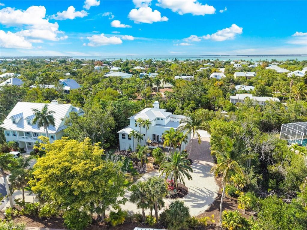 One of Sanibel Island’s treasured secrets is Kinzie Island, a private, gated waterfront enclave that feels worlds apart from the everyday. This gated community of only 22 residences is adjacent to Sanibel’s renowned shelling beaches and defined by serene canals, manicured grounds, and an unmistakable sense of privacy and prestige. 

In this oasis, on over a half-acre lot, is an exceptional canal-front home offering an effortless blend of relaxed island living and understated luxury. Lush tropical landscaping with stately palms add to the mystic of the property. Outdoor living unfolds across multiple levels. Sip morning coffee on the front balcony, host breezy afternoons or sunset dinners on the spacious, back lanai featuring a striking tongue & groove ceiling, and overlooking the canal, or retreat to the third-floor sundeck where panoramic skies, sunshine, and salt air set the tone for island life & amazing sunsets. Inside, the residence is warm, inviting, and thoughtfully done in an eclectic blend of old world charm and contemporary design that speaks to both daily living and entertaining. The kitchen, functional and stylish, features a high-end gas range, wine cooler, and an expansive center island with seating, creating a natural gathering space for casual mornings or lively evenings with friends. It opens to an opulent dining area enhanced by a striking fireplace, adding ambiance and comfort for intimate dinners and special occasions alike. An expansive living room and sitting room provide ample space for family and guests. Two primary bedrooms, one on the main level, and one on the third floor, add accessibility and convenience. Surprising bonus space will delight along with a 3 car garage perfect for all your toys.  A private dock with boat lift places open water right in your backyard, perfect for days spent cruising the Gulf, fishing at sunset, or exploring the area’s natural beauty by boat.

Kinzie Island provides an unmatched island lifestyle where residents enjoy access to a heated lap pool, tennis, pickleball, and bocce courts, and more.  Neighbors are convivial and welcoming. Just across the street, the private beach club provides easy access to the Gulf, complete with a fitness center, restrooms, beach storage, and a dedicated walkway to the sandy beach. This home presents a rare opportunity to experience an intimate, waterfront lifestyle defined by privacy, natural beauty, and the magic of Sanibel Island. Kinzie Island properties are limited, making this offering as exceptional as the setting itself.