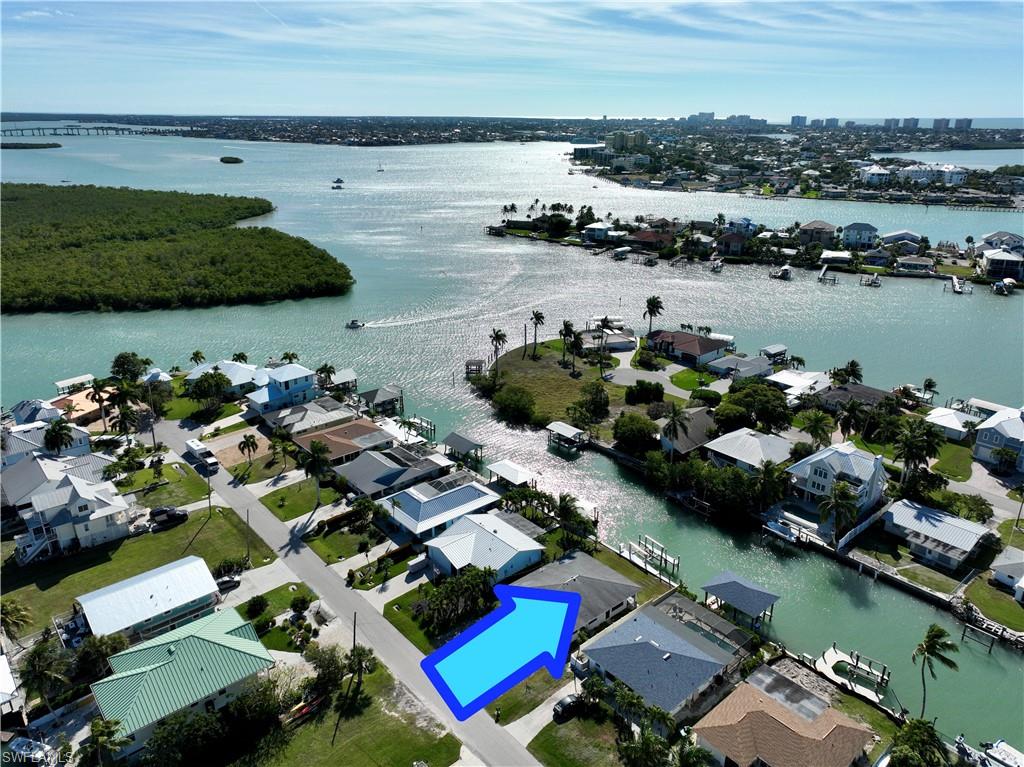 Amazing opportunity to get an income producing, waterfront duplex, on the beautiful Isles of Capri. This grandfathered-in duplex has concrete block construction with (2) two bedroom and two bathroom apartments on each side. Recently, completely remodeled and updated, from the slab up. Updates include all new plumbing, electrical, counters, cabinets, appliances, hurricane-impact windows, doors, sliders and more. There is a big back yard with plenty of room to build a pool and Chickee hut or plant the garden you've always wanted. The seawall, dock and 20k boat lift was also just built, so the only thing left to do is, either rent it out or start enjoying it. Located near the beginning of the canal with the highly desired, Southern Exposure and good fishing off the dock during the day and night. It's the perfect spot for all water enthusiasts. You're surrounded by mangroves and protected waters making it the ideal place to go kayaking and paddle boarding, where you will play with the manatees and dolphins that call our waters home. Take advantage of the quick, direct access to the Gulf of America, and jump on the boat to go island hopping or catch one of our unforgettable sunsets, even if you only have 5 minutes to get to there. You can live the island lifestyle you've always dreamed of in one side and collect money every month from the other, or rent out both units to maximize the revenue. Here you get the best of both worlds, Island Life and a great investment that produces income every month. Isles of Capri is a sub-tropical island that has NO HOA or fees and boasts an abundance of wildlife, four great restaurants and three marinas. Located one mile from Marco Island & only 20 minutes away from Downtown Naples with its sophisticated shopping & five star dining. Our area is famous for its white sand beaches, world class fishing & boating and fantastic golfing. Capri is the perfect place to sit back, relax, unwind and let the sights, sounds and smells sooth your mind, body and soul.