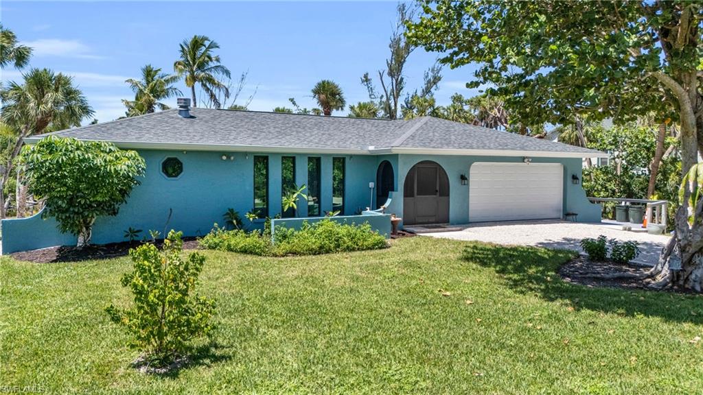 Renovated Sanibel Island Retreat Just Minutes to the Beach. This beautifully renovated Sanibel Island home presents EXCEPTIONAL value just moments from the island’s renowned beaches and Gulf waters. Blending modern upgrades with relaxed coastal living, the home has been thoughtfully redesigned to provide both style and long-term peace of mind. Inside, the light-filled open floor plan showcases durable porcelain tile flooring throughout and a striking fireplace that serves as a focal point for the main living area. The fully renovated galley kitchen features quartz countertops, a farmhouse sink, recessed lighting, and brand-new stainless steel appliances—delivering both functionality and contemporary coastal design. Extensive improvements enhance the home’s quality and resilience, including hurricane-rated windows and sliding doors, a new roof, soffits, and seamless gutters. Additional system upgrades include updated electrical, a new A/C compressor and handler, water softener, jacuzzi tub, washer, and dryer—ensuring comfort and reliability for years to come. Outdoor living is equally inviting with a screened lanai finished with pavers, surrounded by lush tropical landscaping, mature palms, and fruit trees. Set on a private half-acre lot, the property also features a double-wide paver driveway and a Wi-Fi–controlled irrigation system for easy maintenance. A rare opportunity to own a fully renovated island home with substantial upgrades at a newly improved price, ideal for full-time living, a seasonal escape, or investment on Sanibel Island.