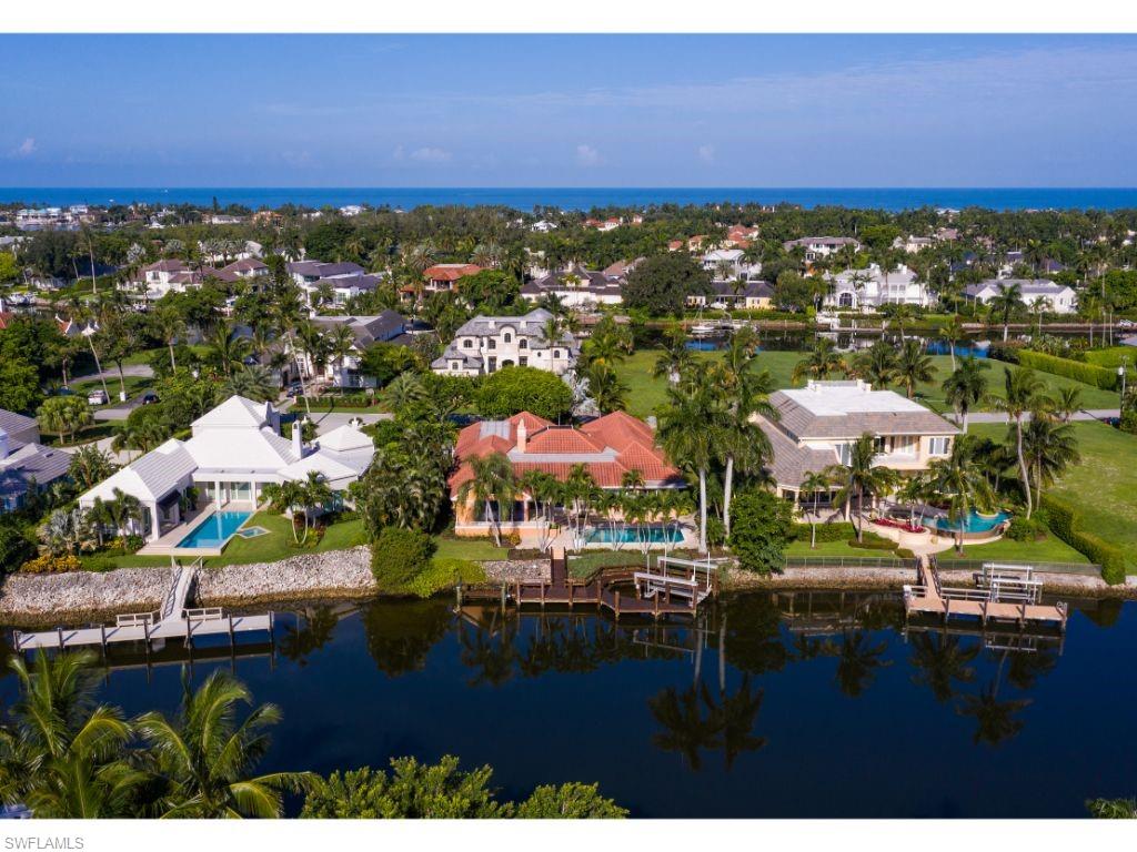 Comfortable setting on Hidden Bay. The home features four bedrooms plus a den, including the master bedroom with a spacious master retreat area. Both the large, open living room and the family room/kitchen areas flow to the adjacent covered lanai and pool deck beyond. Three car garage. Best of all, these accommodations are on one living level. For the boater, a dock is just steps from the house with no-bridge access to the Gulf of Mexico. Port Royal Club membership eligibility.