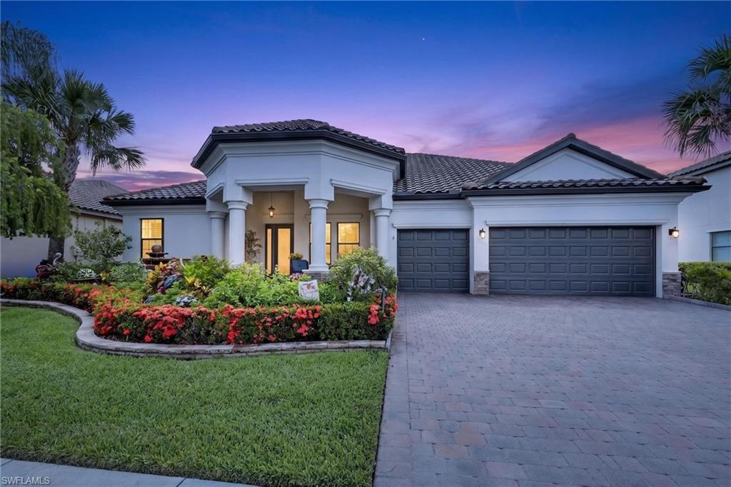 Luxury and peaceful lake views await in this exceptional lakefront home with a heated pool and spa, located in the highly sought-after gated community of Reflection Isles. Situated on a generous .26-acre lakefront homesite with desirable southeastern rear exposure, this beautifully maintained Doral model offers the ultimate Southwest Florida lifestyle with 4 bedrooms, 3 full baths, a 3-car garage, and a premium Trane HVAC system installed in 2025. Offering over 2,550 square feet of thoughtfully designed living space, this home reflects quality, comfort, and pride of ownership.

From the moment you arrive, you'll appreciate the lush tropical landscaping, freshly sealed paver driveway and lanai, and meticulous attention to detail. Designed for both entertaining and everyday living, the popular floor plan features two separate living areas, allowing family members and guests to enjoy their own space while remaining connected.

The beautifully updated kitchen showcases white cabinetry, quartzite countertops, a large center island, pot filler, upgraded sink and disposal, pantry, breakfast area, and abundant cabinet space. Plantation shutters, luxury vinyl flooring in all bedrooms, upgraded lighting, tray ceilings, and custom finishes complete the home's elegant yet inviting design.

The spacious primary suite offers peaceful lake views, custom closet organization, dual vanities, a freestanding soaking tub, separate walk-in shower, and direct access to the lanai.

Relax or entertain on the screened lanai featuring a smartphone-controlled heated pool and spa overlooking the tranquil lake.

Additional improvements include upgraded roof ventilation, a new pool and spa control board, professionally sealed pavers, enhanced tropical landscaping with a beautiful three-tier fountain, updated ceiling fans, electrical upgrades, grab bars in the primary bath, and a motorized overhead garage storage lift that provides safe, convenient access to additional storage without the need for a ladder.

Reflection Isles offers low HOA fees and outstanding resort-style amenities, including a clubhouse, community pool and spa, fitness center, tennis, pickleball, basketball, playground, library, sidewalks, and gated security. Conveniently located near RSW International Airport, Gulf Coast Town Center, Bell Tower Shops, FGCU, Lee Health, Twins and Red Sox Spring Training facilities, shopping, dining, entertainment, and Southwest Florida's beautiful Gulf beaches.

Beautifully maintained, thoughtfully upgraded, and perfectly positioned on one of Reflection Isles' premier lakefront homesites, this exceptional residence is ready to welcome its next owners home.