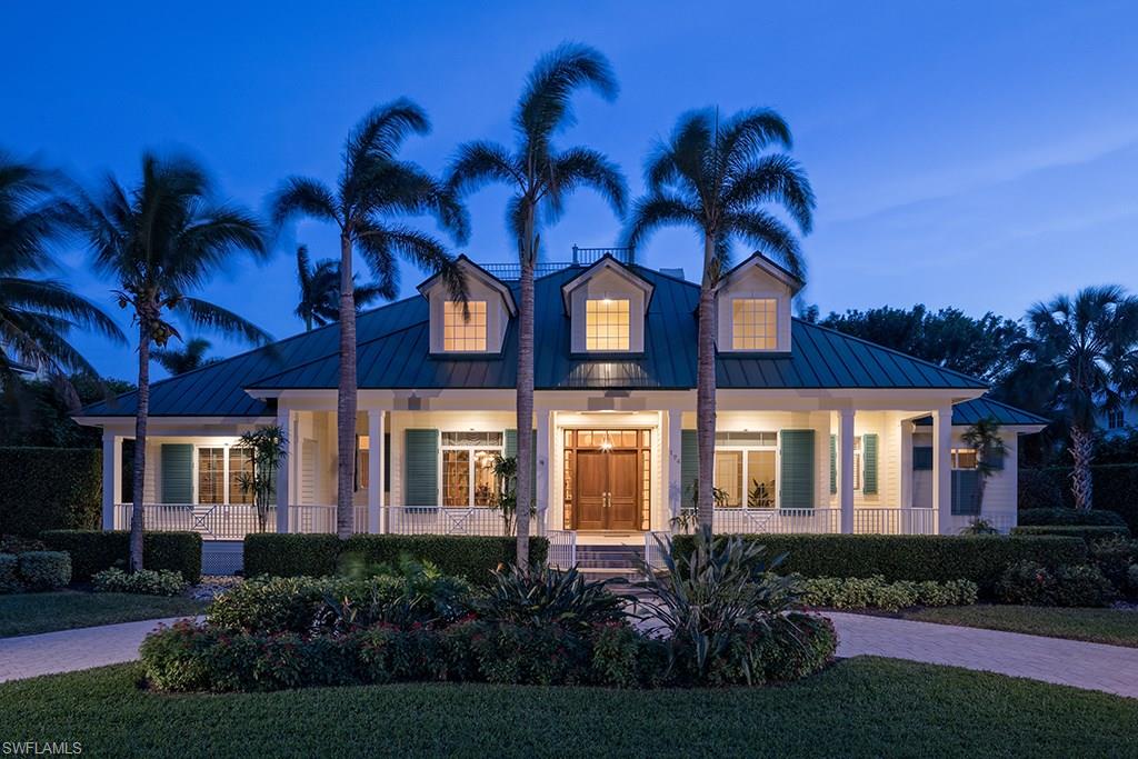 Situated less than 2 blocks to the famous sugar white sand beaches of Old Naples, this 5 bedroom plus den home is a comfortable masterpiece of Old Florida style architecture. Thoughtfully designed to take full advantage of the exceptionally large Old Naples property, all interior living areas are on one level with the exception of a large guest suite located above the spacious 3 car garage. Exciting outdoor spaces with a tropical pool setting, significant pool deck, beautiful gardens, and a covered living area featuring an outdoor kitchen, provide the ultimate Florida lifestyle!  A remarkable property conveniently located in close proximity to upscale shops and fine dining in Old Naples!