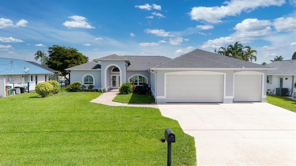 Attention Car/Toy collectors!! & Boaters!! very unique rare true 6 car garage Gulf access pool home!!! this home offers it all & has been updated, new roof 2023, new impact windows & rolldown hurricane shutters on the lanai 2024, A/C 2021 & newer hot water heater, as soon as you walk in the double door entry of this vaulted ceiling entertainer you see the open split plan layout & attention to the remodeling that has been done, tiled foyer, formal dining area, new laminate flooring & baseboards, 8 ft. sliding glass doors in the living room that lead out to your screened tropical pool oasis, with new Kevlar electric hurricane shutters overlooking the canal, the updated eat in granite cherry kitchen includes tiled flooring, sliders to the lanai, Frigidaire stainless steel appliances, large breakfast bar, walk in pantry & recessed lighting that connects to the large vaulted ceiling family room with tiled floors & a view of the water, the main bedroom suite offers 8ft. sliders out to the lanai, tray ceiling & two walk in closets, the main bath includes a soaking tub & a tiled walk in shower with two sink vanity's & a private lavatory, there are two additional nicely appointed guest bedrooms on the other side of the house with new plank tile laminate flooring, there is also a full vaulted ceiling, guest bath with a tub down the hallway, inside laundry, the 6 car tandem garage is amazing!!! & offers its own separate zone of A/C, the commercial air compressor is included in the sale, the garage addition was all permitted in 2017, auto sprinkler system, back yard faces North to have sun all day on the pool lanai, boat dock has support poles in place but needs to have new lift installed, this location is a 25-minute ride to the river, close to I-75, RSW Airport, & 25 minutes to Fort Myers Beach, this is a must see home if you have cars, toys & want to enjoy boating in Southwest Florida!!