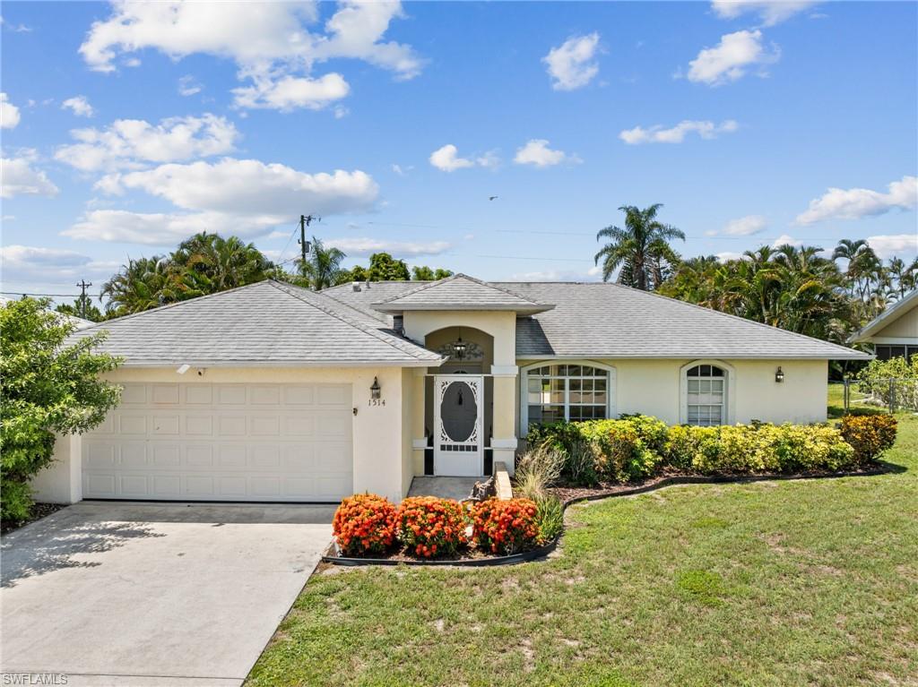 Welcome to your slice of Southwest Florida living, where every day feels like a vacation and evenings are reserved for unforgettable sunsets. This remodeled, then beautifully maintained 3-bedroom, 2-bath pool home in the heart of Cape Coral offers the perfect balance of comfort, style, and outdoor enjoyment. Located in Zone X, this property requires no flood insurance, providing incredible long-term savings and peace of mind. Plus, all utility assessments have been paid in full! 

Head inside and immediately appreciate the clean, modern feel with gorgeous tile floors flowing throughout—no carpet anywhere. Built in 1996, this 1,241 sq. ft. home welcomes you with a screened entry and opens into a bright, spacious living area highlighted by soaring cathedral ceilings. The kitchen and living spaces have been thoughtfully refreshed with updated appliances and fresh paint, making this home truly move-in ready.

Head out back to experience true Florida living! The spacious, screened lanai features a sparkling pool with highly desirable Southern exposure, ensuring perfect year-round sunshine. The pool deck offers plenty of room both under roof and around the pool for outdoor furniture, entertaining, and hosting guests. Beyond the lanai, mature landscaping surrounds all three sides of the rear yard to create an exclusive, private experience. This large, fully fenced backyard provides unmatched privacy and flexibility, offering plenty of room for outdoor living, pets, or gardening.

Perfectly positioned in a quiet, desirable neighborhood with low traffic volume, this home offers a tranquil retreat without sacrificing convenience. You are located just south of the rapidly expanding Pine Island Road business corridor, meaning premier shopping, dining, and everyday conveniences are just minutes away. In a fantastic location due to the home's proximity to Route 41, I-75, and the Caloosahatchee Bridge, making commuting and traveling a breeze! Homeowners will also benefit from nearby top-rated schools. For outdoor enthusiasts, parks, boat ramps, and waterfront activities are just a short drive away.

Complete with a 2-car garage, this exceptional home offers the perfect blend of style, comfort, and location. Whether you’re searching for a seasonal retreat, an investment property, or a full-time residence, this home presents an excellent opportunity to enjoy affordable Florida living.

This is more than just a place to live—it’s an invitation to enjoy the very best of Cape Coral with space, privacy, and sunsets that never get old. Schedule your private showing today!