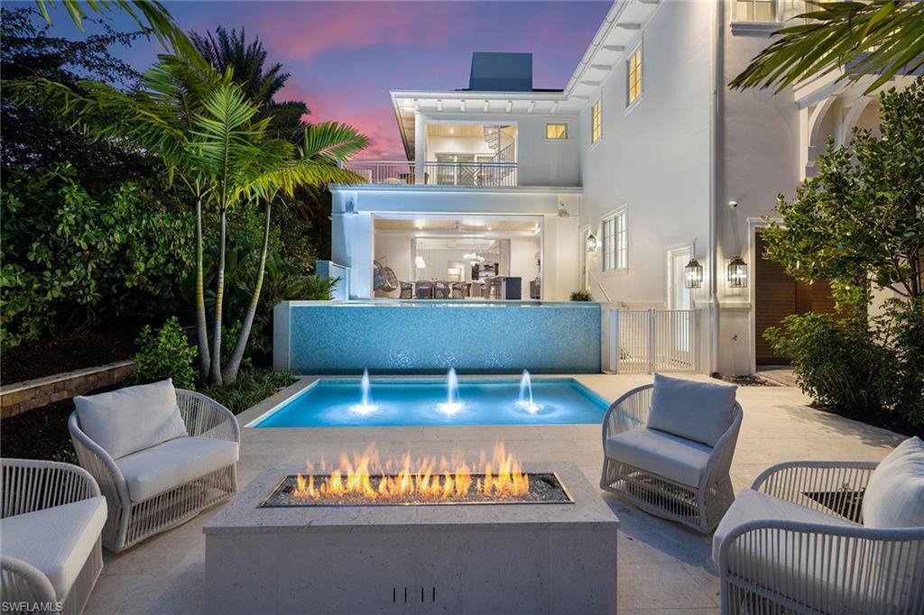 One or more photo(s) has been virtually staged, AI generated or rendered.  Now is the time to purchase and apply for Associate Membership at the prestigious Port Royal Club. This rare Sabre Cay offering includes a 30-foot deeded boat slip and exclusive private beach access reserved for Sabre Cay residents. Move right in and begin living the Naples dream. This brand-new AVA construction masterpiece is complete and ready to enjoy today. With six bedrooms, seven full baths, and three half baths, every detail of this MHK-designed coastal estate reflects impeccable craftsmanship and timeless sophistication. Inside, discover refined elegance at every turn: a temperature-controlled glass wine room, gourmet kitchen, and a main-level primary suite featuring dual spa-like baths and serene views. As the sun dips below the Gulf, retreat to your rooftop oasis—the perfect setting for sunset cocktails, quiet stargazing, or unforgettable evenings with family and friends. Design elements and furniture curated by Design West are all included. This is more than a home—it is a statement of beauty, comfort, and exclusivity. 12 Sabre Lane is where architectural excellence meets coastal serenity. Opportunities like this are rare and fleeting. Seize it before it’s gone. One photo of the garage car lifts has been virtually staged.
