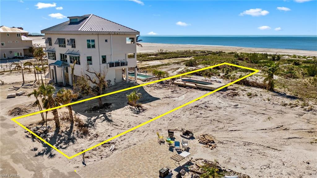 BUILD YOUR DREAM HOME on Fort Myers Beach! There are only a handful of GULF FRONT HOMES that have a buffer between Estero Blvd and Gulf Rd, therefore your property gains more privacy and gives you an all around peaceful time while enjoying the SUNRISE on the front of your home and SUNSET in the back!
This very DEEP and 65' wide oversized parcel leaves you with plenty of options to build whatever your heart desires. ILLUSTRATION OF HOME ATTACHED IS NOT INCLUDED IN THE SALE PRICE. DIRECT BUILDER INTRODUCTION AVAILABLE. Only a few Fort Myers Beach Beachfront homes offer you breathtaking water views and yet privacy in you sandy backyard!
Perfectly situated with easy access going south to the Airport or Dining in Bonita Springs and Naples. Home designs and Builder introductions are available. Walkable to Santini Plaza, the Marina and shops and restaurants. Hurry up...come and see this amazing home site.