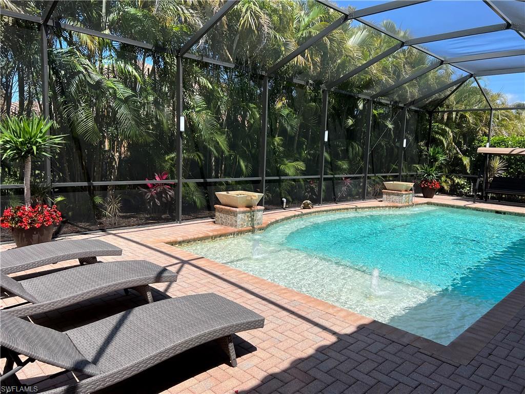 Look no further! This rarely available and absolutely gorgeous Bal Harbor model features 3 large Bedrooms+ huge Den and 3.5 Baths with over 3,100 sq.ft of interior living space plus expansive covered lanai and stunning views of the pool with custom LED lights, fountains and waterfalls! High quality finishes and upgrades including; custom window and ceiling moldings, wood paneled walls, custom columns, wainscoting and tray ceilings. You'll love chef's island kitchen with double ovens and, of course the extensive custom wood cabinet built-ins. The Master Suite features oversized his & her walkin closets and master bath with spacious shower, separate tub and dual vanities. Two Guest Suites each have their own bath. Entertain in style in an open concept floorplan where the Great room, Wet bar, Dining and Kitchen all flow to the outdoors paradise with multiple entertainment  areas. New custom landscaping and lighting add ambience. Located in a social, vacation inspired gated community for all ages. Including multiple pools, clubhouse, indoor/outdoor basketball, fitness center, a social room, tennis courts, playground and much more! A+ school district, close to shopping, I75 and beaches!
