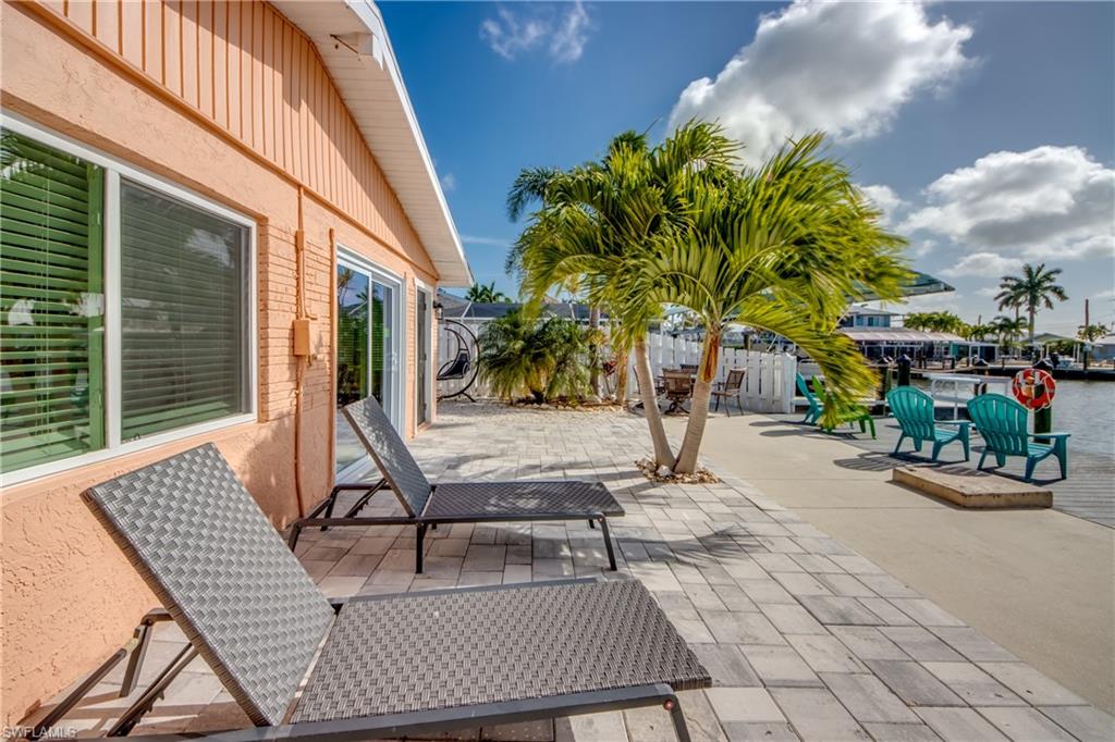 Live Your Best Island Life in this Beautiful Direct Deep-Water Access Island Home! Surrounded by incredible nature, world-class fishing and pristine beaches, this 3 BEDROOM, 2 BATH home is located in the heart of Matlacha and is just a short walk to cool and funky boutiques, great local restaurants and entertainment. This spacious home has been completely remodeled AND comes TURNKEY! The entire home has been tastefully renovated including, new kitchen with stainless appliances and granite countertops, new baths, decorative paneling throughout, impact sliding glass doors, impact windows (with the exception of 2 in the kitchen) and a fresh neutral paint job. The main living space is very open and offers a vaulted ceiling with tons of windows that really allow you to enjoy the surrounding natural beauty. The fully fenced outdoor living space really makes this retreat special! Watch the dolphins and manatees play or take in one of the famous Matlacha sunsets from the large pavered patio that spans the back of the home. There is a custom coach swing that is the perfect place to unwind or read your favorite book! Boating is a breeze with the oversized composite dock complete with an angled 10k boatlift, open water is a short 3-minute boat ride away! The double driveway offers ample parking which is a premium in Matlacha. In addition to its many upgrades, this property is also eco-friendly with low maintenance, water wise landscaping. Come see this home today and start Living the Island Life!