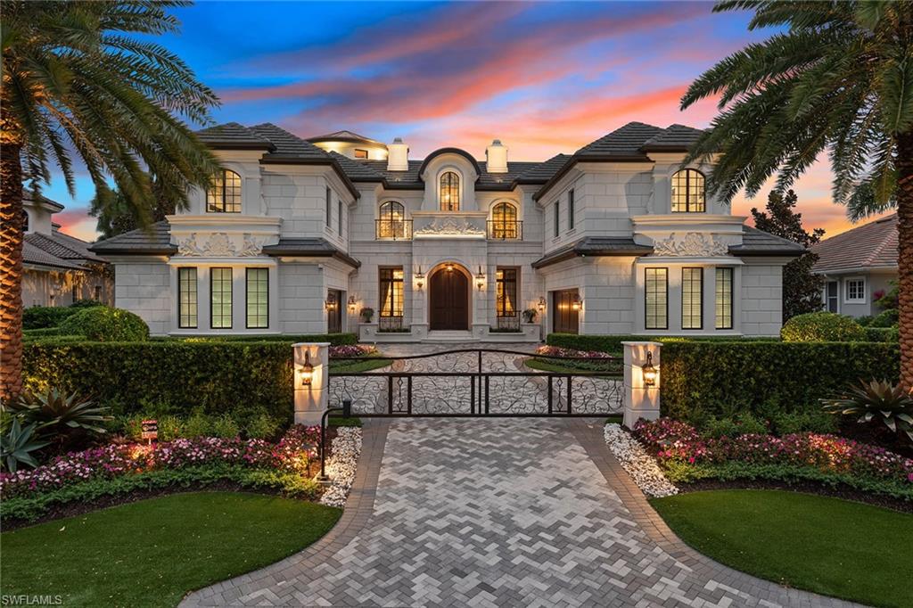 A masterfully crafted custom waterfront residence located within minutes of the best Naples has to offer. This home exudes timeless elegance with exquisite attention to detail like its soaring living room and rotunda which both feature gold leafing on the ceilings, Italian crystal lighting, lavish furnishings, custom ceiling designs in every room, a stunning 600-bottle climate-controlled wine vault, a beautifully appointed kitchen featuring a 12-foot island and a smart home system that controls music, lighting, window shades and much more. The expansive floor plan wonderfully showcases the meticulously designed spaces such as a 4-car garage and elevator, 4 en-suite guest bedrooms with elegant finishes, a private study, a second-floor lounge with custom wet bar and the incredible master suite which features a fireplace, dual bathrooms and dual master closets which will truly impress. The coral-stone lanai, pool deck and dock are perfect for entertaining with automated shutters, awnings and screens, an outdoor kitchen, infinity saltwater pool/spa and 3 fire features. This one-of-a-kind home was lovingly built, designed with every detail in mind and is ready to impress.