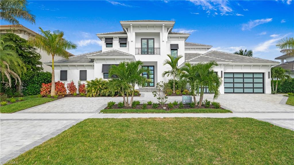 Luxurious Coastal Paradise with Breathtaking Views! Just Completed! This incredible 4 bedroom plus office, 4 bathroom, direct Gulf access, coastal contemporary home leaves nothing to be desired. The entry foyer opens to a huge great room with 12’ custom ceilings and 10’ tall sliders and windows that provide an abundance of natural light, while offering amazing views of Smokehouse Bay. The kitchen, complete with Amish-built custom cabinetry, quartz and quartzite countertops, premium Thermador appliances, walk-in butler’s pantry, and large island, overlooks the morning room and stunning water views. The master suite, located on the 1st floor, has an 11’ ceiling, two walk-in closets, separate vanities, oversized shower, and a soaking tub. Access the outdoor covered and screened lanai from the master suite, pool bath, great room, or morning room and enjoy the built-in fireplace, electric shades, custom outdoor kitchen, pool with integrated waterfall spa, and sun deck. The breathtaking views continue upstairs with the 2nd floor featuring another great room, complete with a wet bar, 2 bedrooms, each with walk-in closets and a Jack and Jill bathroom, and a 4th bedroom with en suite bathroom. The oversized upstairs lanai provides picturesque panoramic views of the Esplanade and Smokehouse Bay, leading out to the Gulf. This masterpiece includes a 1000-gallon propane tank, 22kW Generac generator, engineered hardwood and custom tile throughout, designer fans and light fixtures, crown molding, shiplap, central vacuum, and much more. The 4-car garage offers architectural glass doors and includes a passthrough garage that is over 40’ deep with rear garage door for quick access to your future dock. This magnificent beach house is centrally located and is just minutes to the white sand beaches of Marco Island, parks, tennis and pickle ball courts, golf, shopping, dining, schools, and the YMCA. Don’t miss the opportunity to enjoy the best of what Marco Island has to offer!