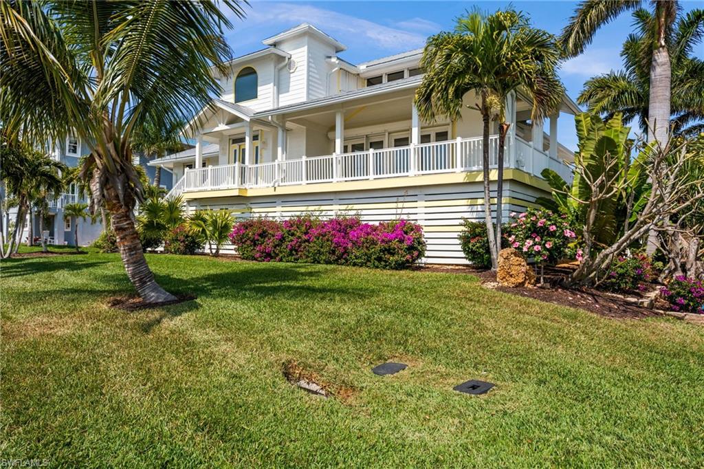 Discover one of Pine Island's most exclusive waterfront lifestyles in the gated boating community of Pine Island Shores, where privacy, exceptional boating access, and relaxed island living come together in a setting unlike any other. Tucked away on a quiet private street, this custom-built waterfront retreat offers 3 bedrooms, 2 baths, a heated saltwater pool & spa, and quick, direct Gulf access from a deep-water canal designed for serious boaters. Whether you're heading to Pine Island Sound for world-class fishing or island hopping to Sanibel, Cayo Costa, Boca Grande, and beyond, you'll be on the water within minutes. Built with durable Hardie board siding & shutters throughout, the home blends coastal elegance with lasting quality and peace of mind. The seawall was replaced in 2023, while the composite dock features a 14,000-pound boat lift, covered captain's walk with hard-top roof, plus water & electric—everything needed for effortless days on the water. Indoor & outdoor living blend seamlessly with a screened balcony off the kitchen & great room, perfect for morning coffee or evening dinners overlooking the water, while the open front balcony offers front-row seats to spectacular Southwest Florida sunsets. Inside, the bright open-concept living area features a spacious kitchen with separate cooktop, vented hood, double wall ovens, stainless steel appliances & oversized walk-in pantry. Two guest bedrooms, full bath, laundry room & elevator complete the main living level. The entire upper floor is dedicated to a private primary retreat featuring a beautifully remodeled ensuite bath with walk-in shower, custom dual-sink vanity & spacious California-style walk-in closet. Downstairs, a rare four-car garage, generous storage & versatile bonus room with half bath provide ideal space for entertaining, hobbies, a home gym or poolside convenience. Pine Island Shores is prized for its peaceful atmosphere, beautifully maintained surroundings, and community standards that help preserve the neighborhood's charm and waterfront character. Residents enjoy the peace of mind of a gated community, quiet streets ideal for walking & biking, limited short-term rentals that help foster a true residential community, and thoughtfully maintained standards that preserve the neighborhood's beauty by minimizing trailer storage, excessive vehicle parking, and visual clutter. Despite its tranquil setting, the community offers convenient access to shopping, banking, dining, medical care, pharmacies, the post office & emergency services. More than just a waterfront home, this is an opportunity to own in one of Pine Island's premier gated boating communities—a place where exceptional boating, privacy, pride of ownership, and an unmatched waterfront lifestyle come together in a setting that is truly rare.