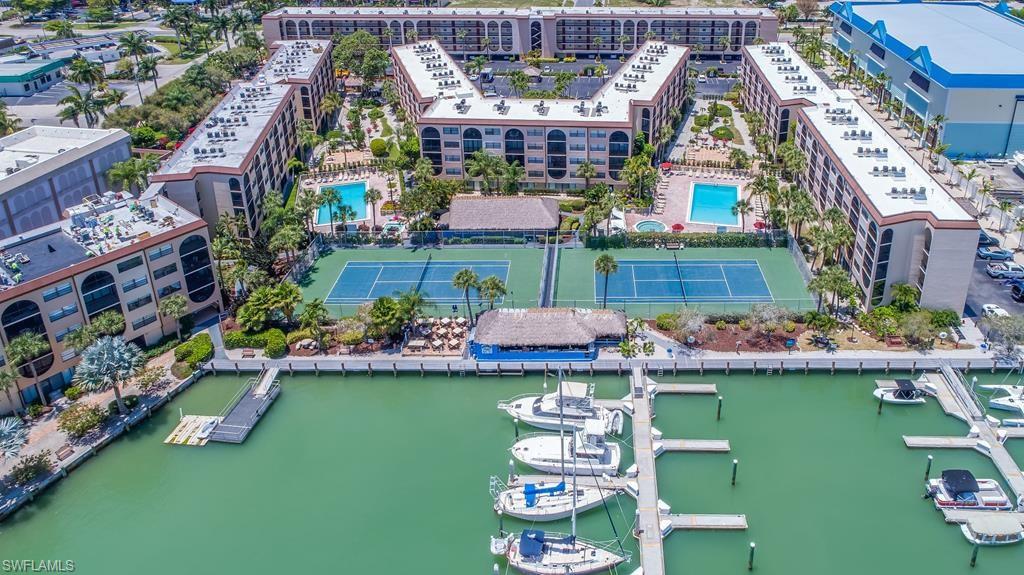 Paradise Found ! Pool and distant bay views from this top floor - one bedroom/one bath condominium. Brand new A/C with warranty (7K value). Lanai has a quiet tropical garden view. Tiled throughout living areas. Spacious bedroom with both full & queen beds. Your island get-a-way or the perfect investment property, Anglers Cove offers resort style living with 2 tennis courts, 2 heated pools, 2 spas, outside waterfront dining at the famous Dolphin Tiki Bar and Restaurant. Boat docks may be leased, when available, with DIRECT ACCESS to the Marco River and the Gulf of Mexico.  The Marco River Marina next door offers fishing charters, lunch & dinner, cruises aboard the Marco Princess, plus Key West boat shuttle runs during season (3 hr. ride one way). Walking distance to other restaurants and shopping. One of the few condominiums on Marco Island that allows WEEKLY RENTALS for maximum income potential. Low monthly maintenance which includes ELECTRIC utility. Being sold turnkey furnished.