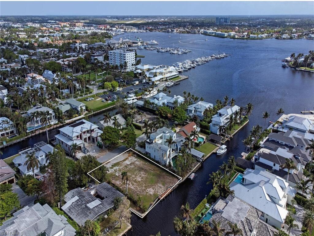 Idyllic, quiet, and luxurious - this waterfront parcel located in the highly coveted Aqualane Shores is a mere three doors from Naples Bay and offers a sizable building envelope to construct a residence of your exact specifications.  The recently cleared 14,000 +/- square foot lot allows a buildable footprint of 7,225 square feet, providing ample space to live and breathe what most Buyers dream. Surrounded by stunning properties, this opportunity offers direct, unrestricted access to several deep-waterways while touting palm tree-lined boulevards and an array of local establishments, as well as Naples' sugar sand beaches, all within walking distance.
