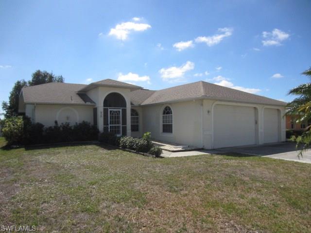 Amazing 3BR/2BA/3 CAR GARAGE home in Central Cape Coral close to public and private services! Exterior shows awesome back yard with space to relax and play in the midst of Fantastic shade trees all prepared for enjoying the true  outdoor South Florida lifestyle. Interior is spacious with soaring cathedral ceilings, planter shelves and open living area with separate dining! ALL TILE floors, UPGRADED KITCHEN, spacious Master Bath with Dual Sinks are among the features that make this home a "top of the list" winner. Don't delay-Schedule a showing TODAY!