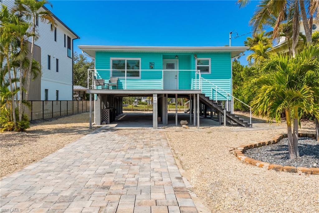 Beautifully RENOVATED Classic Florida Beach Cottage. Perfectly positioned along a GULF ACCESS CANAL, this ELEVATED beach cottage offers classic island living at its finest. ROOM FOR A POOL. Great for Personal use and RENTAL INCOME. Recently RENOVATED to perfection, the residence showcases stunning flooring, vibrant coastal tones, and a seamless blend of modern coastal elegance and timeless design. The open-concept living area flows effortlessly into a spacious screened-in balcony, where tranquil water views set the stage for relaxing mornings and breezy evenings. This serene outdoor space connects beautifully to both the main living area and the primary bedroom, offering an ideal indoor-outdoor lifestyle. Recent improvements include a new driveway, along with updated fixtures, lighting, and finishes throughout, complemented by tasteful coastal furnishings and new interior window treatments that add a refined finishing touch. Impact-rated windows and sliders installed in 2022 provide peace of mind, durability, and energy efficiency. The property also offers room for a pool, enhancing both lifestyle enjoyment and rental appeal. Just a short, enchanting stroll to the sugar-sand beach, this home blends coastal charm with modern updates, creating an inviting retreat for personal enjoyment or income-producing potential.Ideally located on a peaceful street with convenient access to the Gulf of Mexico and bay via the backyard canal, this home is perfectly suited for boating enthusiasts, beach lovers, and those seeking a refined island escape. Whether envisioned as a personal sanctuary or an income-producing opportunity, this exceptional property invites you to experience the very best of coastal living.
