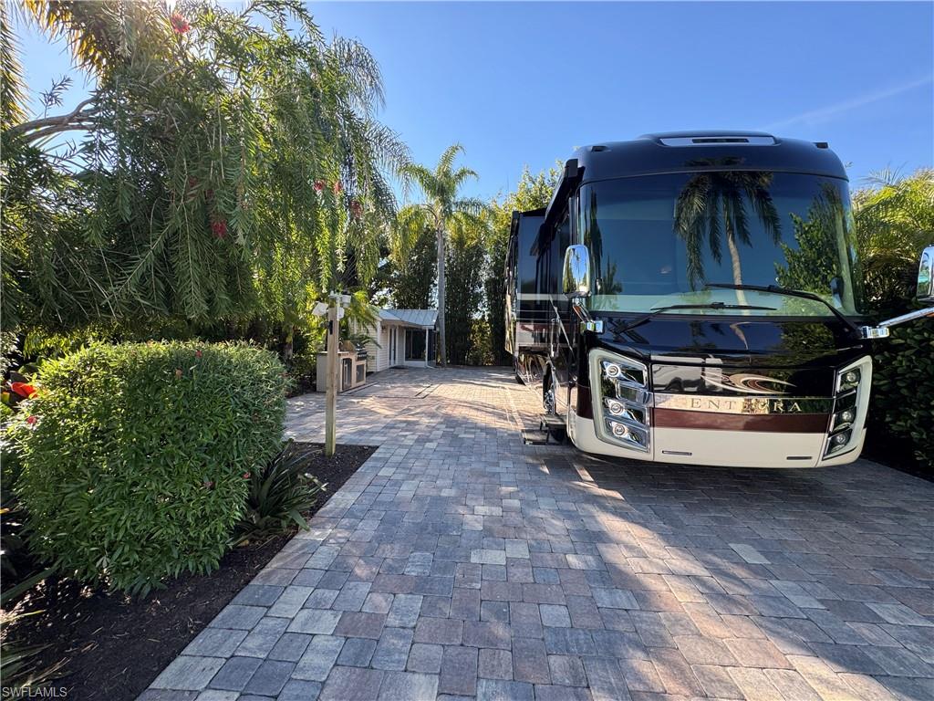 Lot 42 Your Private Oasis in Paradise. Discover the perfect blend of comfort, privacy, and resort-style living with Lot 42 at RiverBend Motorcoach Resort. This exceptional property offers the best of all worlds, a fantastic price, lush surroundings, and a beautifully bright coach house nestled beneath a shady canopy of palms. The coach house is thoughtfully designed for both relaxation and convenience, featuring a mini-split AC, a kitchenette, a washer and dryer, a cozy bathroom with a shower, and a coveted screen room perfect for enjoying the tropical breeze without the bother of rain or bugs. Situated on a peaceful street near extra parking, this desirable back-in lot boasts full pavers and a well-equipped outdoor grilling kitchen, ideal for entertaining. Towering trees and swaying palms provide a natural sense of seclusion and abundant shade, while the spacious layout offers room for a lanai, bike storage, or additional outdoor essentials. At RiverBend, every day feels like a vacation. A private boat ramp grants direct access to the scenic Caloosahatchee River, while the grand clubhouse and bar create a welcoming hub for social gatherings. Indulge in endless recreation with a stunning resort-style pool, a lively cabana bar, two hot tubs, and a wealth of activities, from pickleball on eight pristine courts to bocce, shuffleboard, and a beautifully maintained putting green. For hobby enthusiasts, the community offers an R/C racetrack, a charming hobby train beneath the oaks, billiards, and an R/C boating club. Beyond the exceptional amenities, RiverBend is a place where neighbors become lifelong friends, where lush landscaping and sprawling green spaces create an atmosphere as inviting as it is exclusive. Recognized as one of the most unique luxury RV resorts in the country, RiverBend is more than just a destination, it’s a lifestyle. Embrace the beauty, the adventure, and the sense of belonging that make RiverBend an unparalleled retreat. Lot 42 isn’t just a place to park your coach; it’s your gateway to paradise.