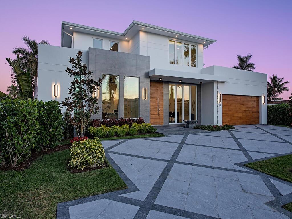 Waterfront dream home! Presenting a stunning contemporary new construction waterfront estate home in the heart of
downtown Naples. This residence offers world class unimpeded boating from your private dock to the Gulf of Mexico and
beyond. Concrete block construction with phenomenal high-end finishes and state-of-the-art home technology located in Royal Harbor, one of Naples premier boating neighborhoods. Adorned with wide plank white oak floors, exotic stone surfaces, and custom cabinets throughout. From the moment you approach a luxurious wood front door you feel the Zen tranquility created through the landscape. 21 foot ceilings and a wall of glass overlooking a resort style saltwater pool and spa surrounded by a Brazilian Teak deck. The open floorplan includes a large first floor master suit with wet bar, safe room, and a stunning limestone finished master bath. The gourmet kitchen is a chef’s dream and is accompanied by a floor to ceiling glass wine room. The second floor includes 3 en suit bedrooms, a large living room with wet bar, and a spacious deck overlooking the waterway. Other notable features include a 3-car garage with room for lifts, whole house audio, new seawall