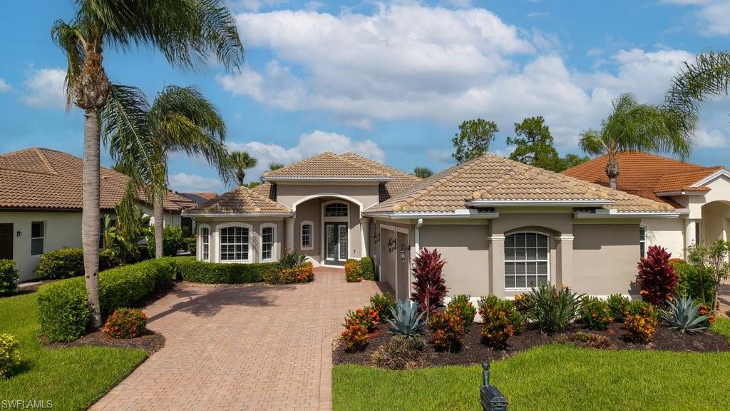 Overlooking the Lake and 7th hole, this immaculate Villa Grande residence located in the highly desirable Grandezza Golf & Country Club creates the perfect Florida backdrop! This Beautiful 3-bedroom, 3-bathroom, 3-car garage and private den features soaring 10-foot ceilings, abundant natural light, and elegant finishes throughout. The spacious open-floor plan brings together the great room, dining area and kitchen, offering a sophisticated yet comfortable gathering space. The modern gourmet kitchen has been beautifully updated with professionally refaced cabinetry (2024), stainless steel appliances, natural stone countertops, and a new refrigerator (2025), making it ideal for both everyday living and entertaining. The large and airy primary suite serves as a private retreat with direct access to the lanai and dual closets connected to a luxurious en-suite bathroom with newly refaced cabinetry, dual sinks and soaking tub providing a timeless elegance. Step outside to your private outdoor retreat featuring a sparkling pool, relaxing spa and covered outdoor living area perfect for soaking in the sun and effortless entertainment. Enjoy the beauty of Florida while taking in breathtaking sunsets and serene lake and golf views year-round from the lanai. Two spacious guest bedrooms provide comfortable accommodations, with one offering a private en-suite and the other enjoying easy access to its own full bathroom. The laundry room offers added functionality with ample storage, featuring a generous closet and upper cabinetry. This beautiful home has been thoughtfully updated, including a new roof (2023), new gutters (2025), whole house painted interior, new landscaping (2025), custom plantation shutters and blinds throughout (2025), and an epoxy-coated garage floor with freshly painted interior (2024). Electric hurricane shutters (2019) provide added convenience and peace of mind. The Club at Grandezza provides access to world-class amenities, including an 18-hole Championship Course with immediate Golf Membership available, a resort-style pool, tennis, bocce and basketball courts, fitness center, and a gorgeous clubhouse with indoor and outdoor restaurants. Ideally located, this home is just minutes from shopping, dining, entertainment, I-75, and Southwest Florida International Airport (RSW). No Flood insurance required or CDD!