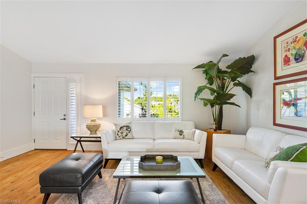 Gorgeous top to bottom renovation by Borelli Construction! This special unit, located at the end of the 18 unit subdivision for quiet enjoyment features cathedral ceilings & both a living & family room/den on opposite sides of the unit (FR w/ 2 walls of glass provides sunset & pool views!). The stunning white kitchen has a breakfast island, gray & white cut stone backsplash, quartz countertops & all new ss appliances plus 2 bonus pantry closets! Both bathrooms are high end tile, frameless glass shower doors & quartz counters. Custom closet organizers in both bedrooms. Solid core 3 panel doors; all new hurricane impact glass tinted windows w/ plantation shutters or blinds throughout allow maximum natural sunlight in. Walk to Walgreens, Publix & multiple restaurants & stores. Venetian Village shopping/restaurants & the private Park Shore Beach Club are also only a mile away. 2 Deeded Covered Carport Spaces come with this unit. All others have only 1. This unit is ready for enjoying the fabulous Naples lifestyle with no work involved and promises not disappoint!