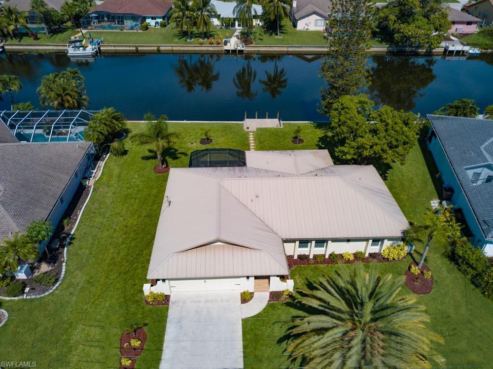 Absolutely gorgeous 3 bedroom, 2 bath home located on a Freshwater Canal in Cape Coral Florida!  The canal leads to the beautiful Manitoba Lake and you have your own private dock so you can explore and enjoy boating, kayaking and fishing! Very large screened in patio with pavers and there is room for a pool! This home has been updated with New Kitchen and Baths, Newer roof, newer AC, All new Flooring and appliances. Most all windows and doors are hurricane proof and this property is not located in a flood zone so save big on your insurance! Move right in-this home is being sold FURNISHED! Very clean, won't last!!