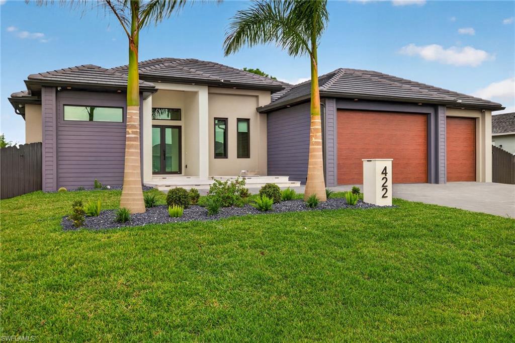 Experience luxury living at its finest in this stunning modern residence located at 422 SW 31st Ave in one of Cape Coral's fastest-growing areas. Perfectly positioned just minutes from the highly anticipated Seven Islands development, this exceptional 4-bedroom, 3-bathroom home with a spacious 3-car garage offers the perfect blend of elegance, comfort, and convenience.
From the moment you arrive, the striking curb appeal sets the tone. A beautiful waterfall fountain welcomes you home, while the tile roof and contemporary architecture create a sophisticated first impression. Inside, soaring high ceilings and an open-concept design provide a bright, airy atmosphere filled with natural light.
Every detail has been thoughtfully designed, featuring custom cabinetry throughout the entire home, offering both style and functionality. The luxurious owner's suite serves as a private retreat, complete with custom-built his-and-hers closets and a spa-inspired bathroom featuring a fully integrated steam shower for the ultimate relaxation experience.
The heart of the home seamlessly flows to the outdoor living space, where you'll find an expansive covered lanai designed for entertaining year-round. The fully equipped summer kitchen includes a cooktop, beer dispenser, and ice machine, making it effortless to host family and friends. Beyond the lanai, the resort-style pool and spa create a true backyard oasis, offering the perfect place to unwind and enjoy Southwest Florida living.
Meticulously maintained and completely move-in ready, this home delivers the luxury lifestyle you've been searching for. Whether you're relaxing by the pool, entertaining guests outdoors, or enjoying the nearby shopping, dining, boating, and future attractions of the Seven Islands project, this remarkable property is ready for you to call it home.