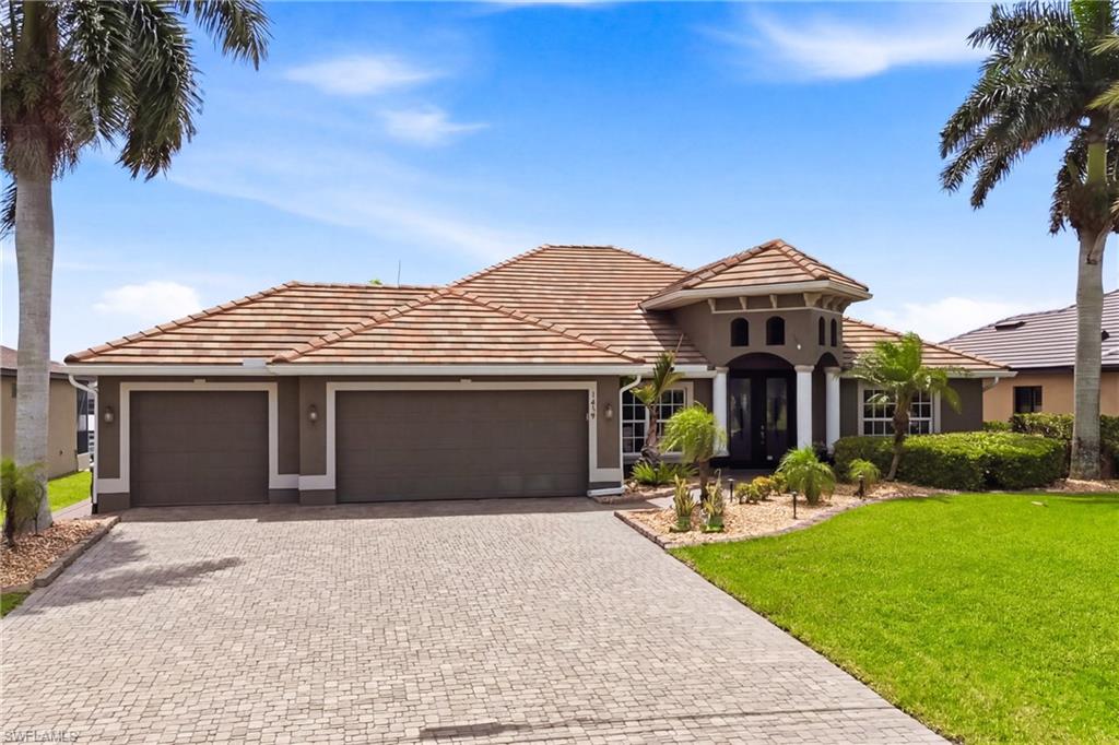 Gulf-access pool home with four bedrooms plus a den, two baths, and a spacious split-bedroom floor plan designed for comfortable Florida living. Ideally positioned on a rare four-way intersecting canal, this exceptional waterfront residence offers expansive water views, eastern rear exposure, and beautiful sunrise mornings.

Boating and fishing enthusiasts will appreciate the approximately 700-square-foot composite dock with a captain’s walk, water and electric service, a covered 10,000-pound boat lift, a 7,000-pound boat lift, and the convenience of being just one bridge from open water. Whether heading out for a day of fishing, cruising the waterways, or relaxing by the canal, this property is designed to make the most of the Southwest Florida boating lifestyle.

The outdoor living area is a standout feature, offering an enclosed heated pool and spillover spa, a large under-truss lanai for outdoor dining and relaxing, and wide waterfront views that create an inviting setting for entertaining or unwinding at home.

Inside, the open floor plan features soaring ceilings, abundant natural light, a spacious great room with built-in cabinetry and an electric fireplace, a formal dining area, and a versatile den ideal for a home office, media room, or additional guest space. The kitchen is designed for everyday living and effortless entertaining with granite countertops, wood cabinetry, stainless-steel appliances, a pantry, breakfast bar, and open views toward the main living area and lanai.

The spacious primary suite features a tray ceiling, private access to the lanai, and an ensuite bath with a granite-topped dual vanity, soaking tub, separate walk-in shower, and private water closet.

Additional highlights include impact-resistant windows and sliding doors, a tile roof, whole-house reverse-osmosis system, paver driveway, mature tropical landscaping, and an air-conditioned three-car garage with tile flooring, workspace, and custom storage cabinetry.

Conveniently located near Tropicana Park, Coral Oaks Golf Course, and the anticipated Seven Islands development. Easy access to shopping, dining, recreation, and entertainment. This exceptional property offers an ideal combination of Gulf access, boating amenities, luxury outdoor living, and relaxed coastal style.