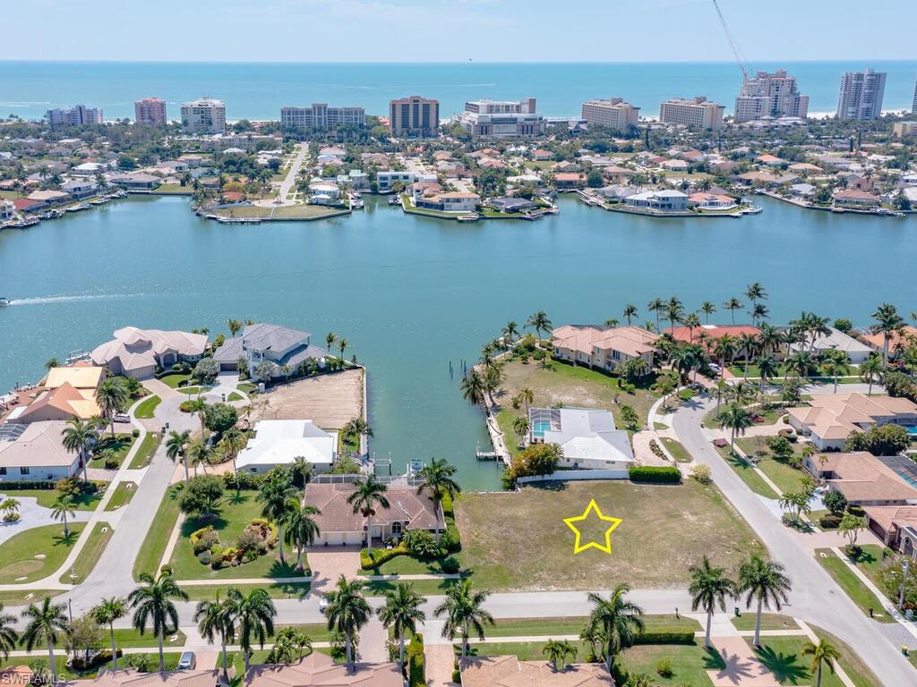 Location, Location, Location at this Water Indirect corner lot on Lamplighter Court! This property is a terrific homesite location in a highly desirable area, Central Island South, near Residents Beach. This waterfront lot is ready to build your dream home. Enjoy daily sunsets from your lanai and views of Landmark Waterway.